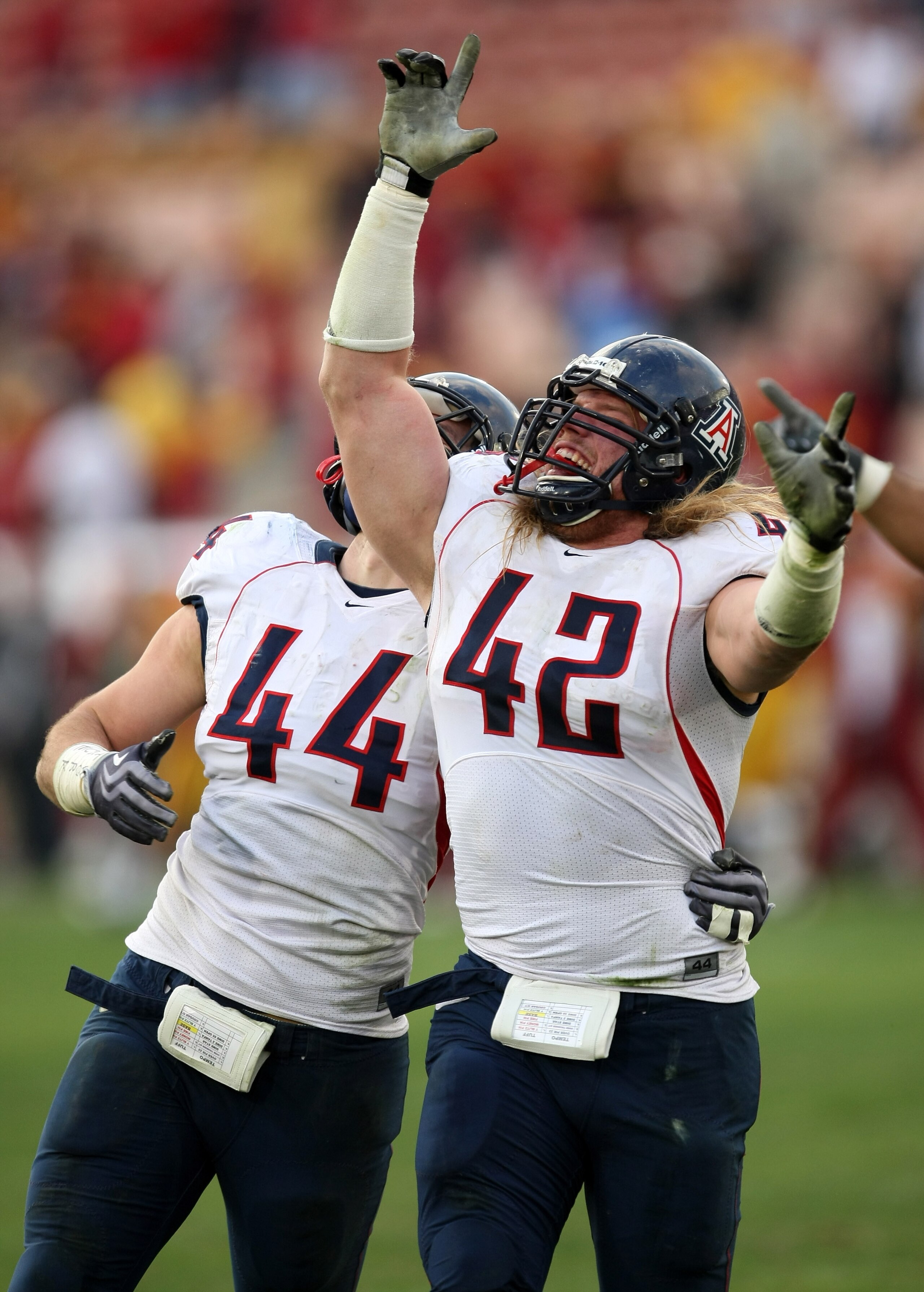LOS ANGELES - DECEMBER 5: Defensive ends Brooks Reed #42 and Ricky Elmore #44 of the Arizona Wildcats celebrate after stopping the USC Trojans on the final play on December 5, 2009 at the Los Angeles Coliseum in Los Angeles, California. Arizona won 21-17 LOS ANGELES - DECEMBER 5: Defensive ends Brooks Reed #42 and Ricky Elmore #44 of the Arizona Wildcats celebrate after stopping the USC Trojans on the final play on December 5, 2009 at the Los Angeles Coliseum in Los Angeles, California. Arizona won 21-17