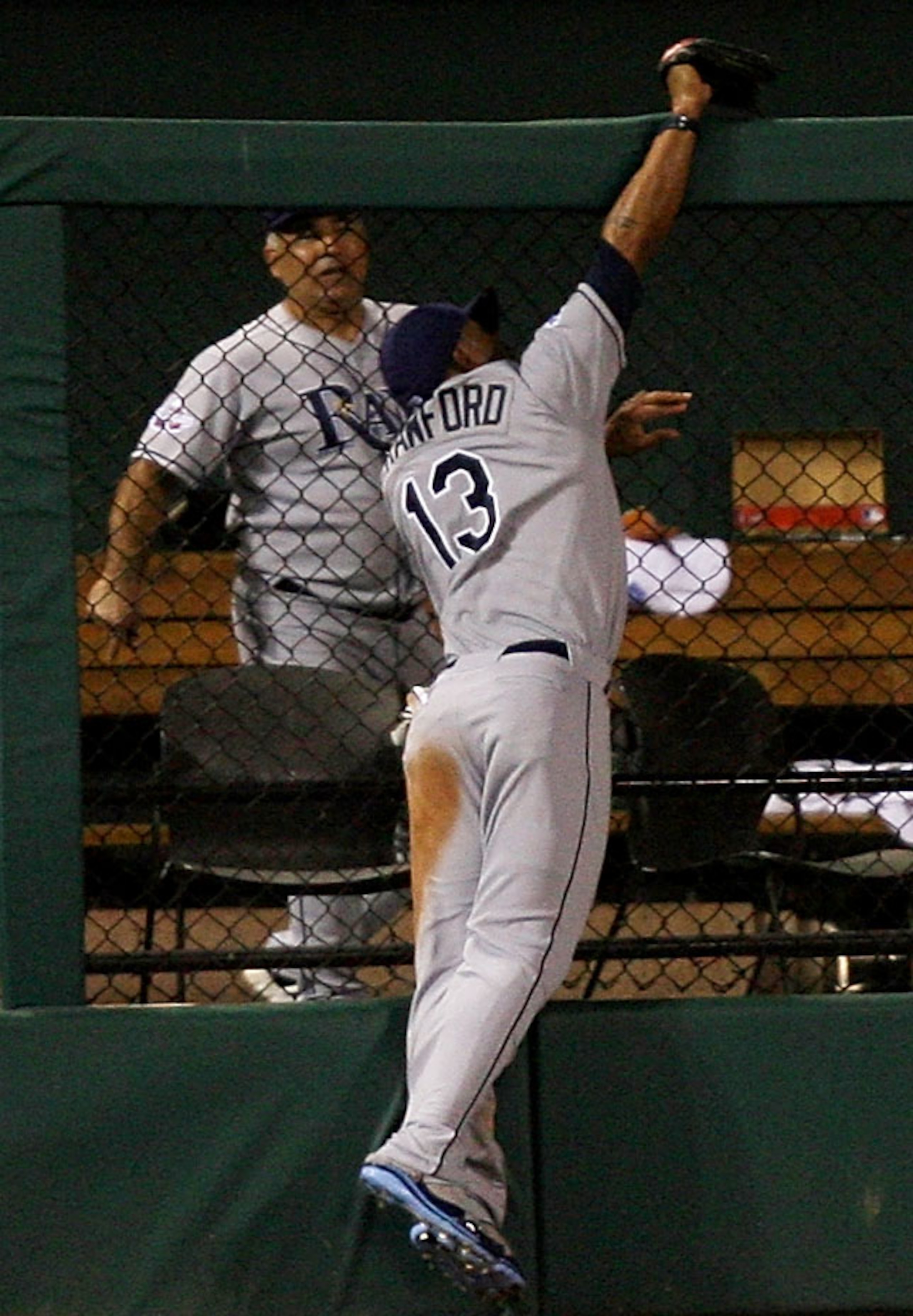ST LOUIS, MO - JULY 14:  American League All-Star Carl Crawford of the Tampa Bay Rays robs a home run from National League All-Star Brad Hawpe of the Colorado Rockies during the 2009 MLB All-Star Game at Busch Stadium on July 14, 2009 in St Louis, Missour