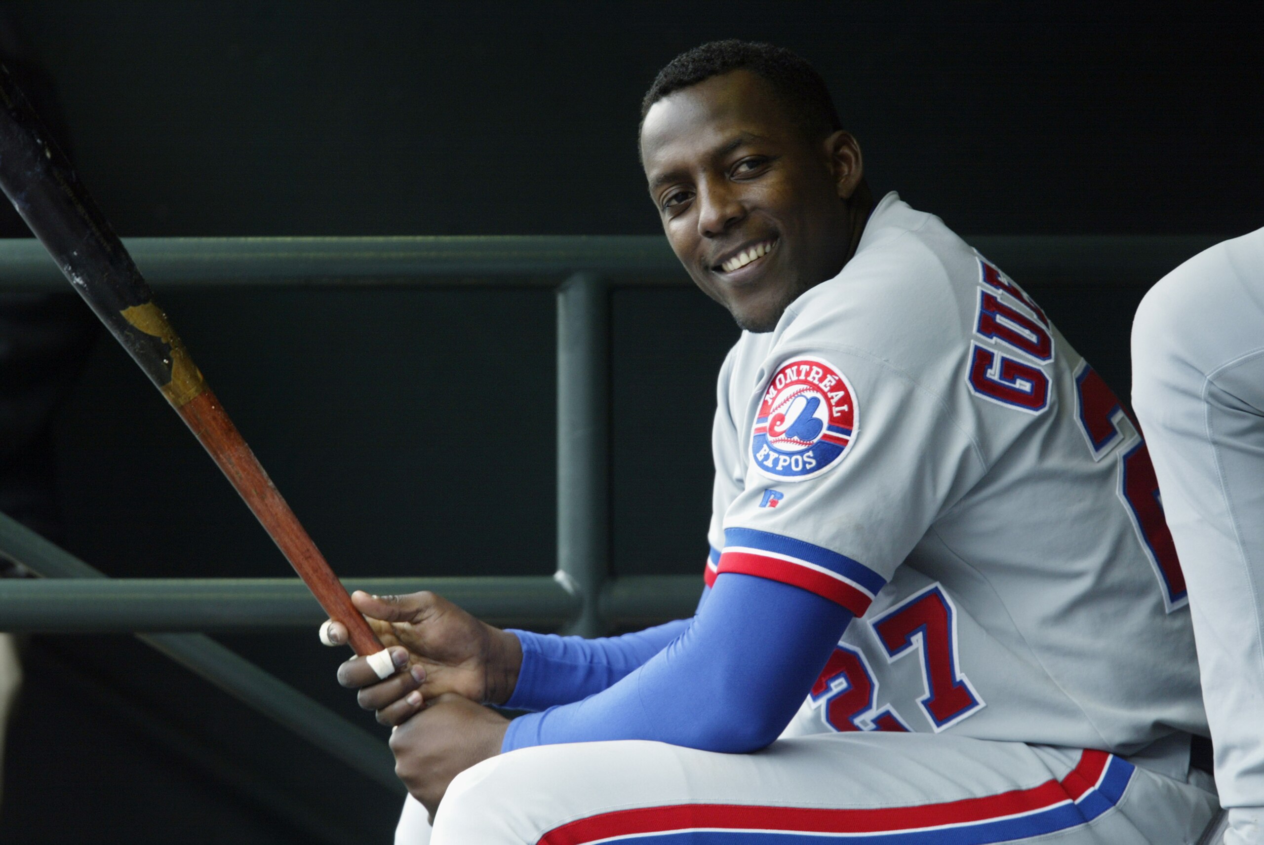 SAN FRANCISCO - MAY 14:  Vladimir Guerrero #27 of the Montreal Expos laughs in the dugout during the game against the San Francisco Giants at Pac Bell Park on May 14, 2003 in San Francisco, California.  The Expos defeated the Giants 6-3.  (Photo by Jed Ja