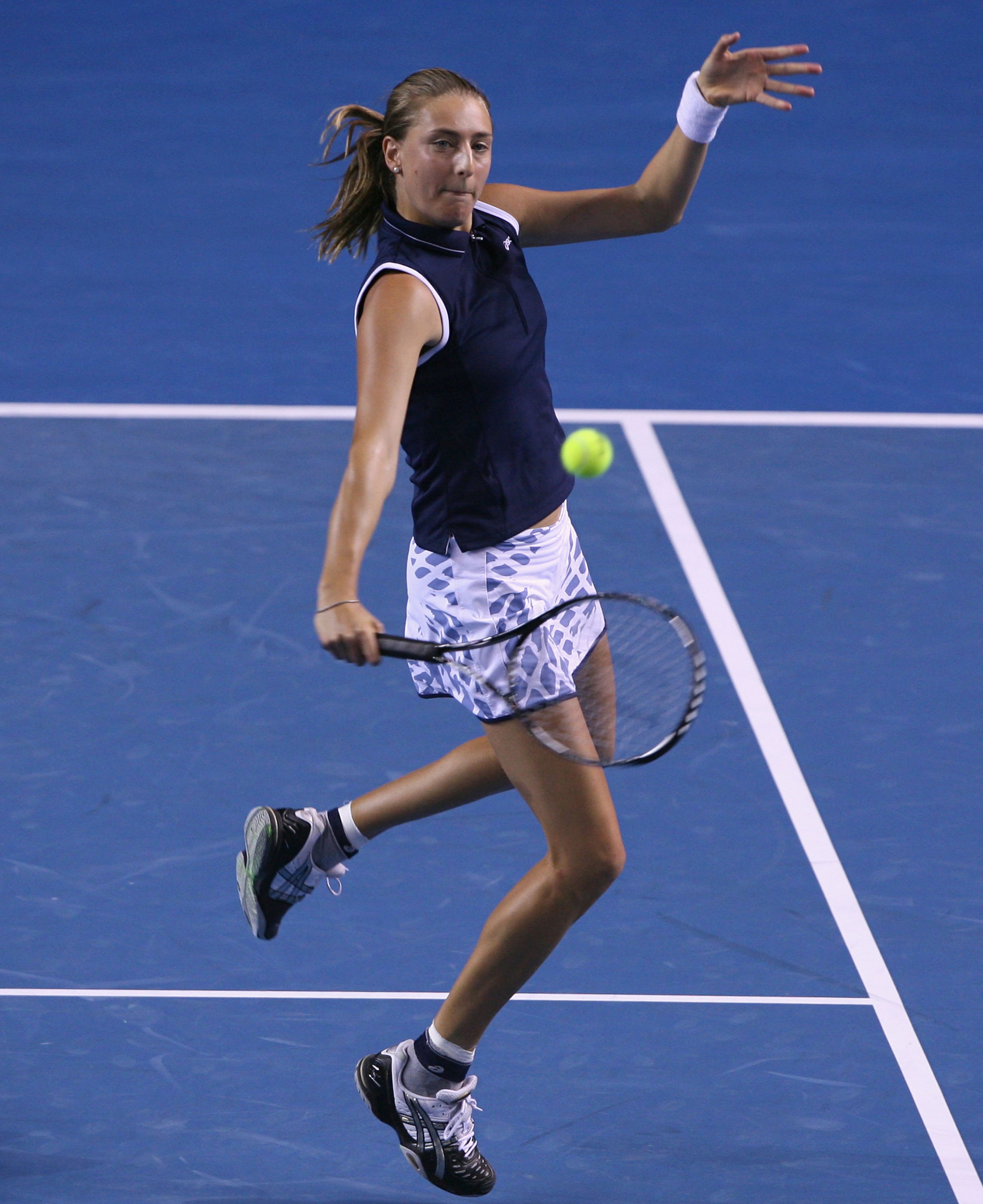 MELBOURNE, AUSTRALIA - JANUARY 29:  Mara Santangelo of Italy plays a backhand in her quarterfinal doubles match with Nathalie Dechy of France against Ai Sugiyama of Japan and Daniela Hantuchova of Slovakia during day eleven of the 2009 Australian Open at