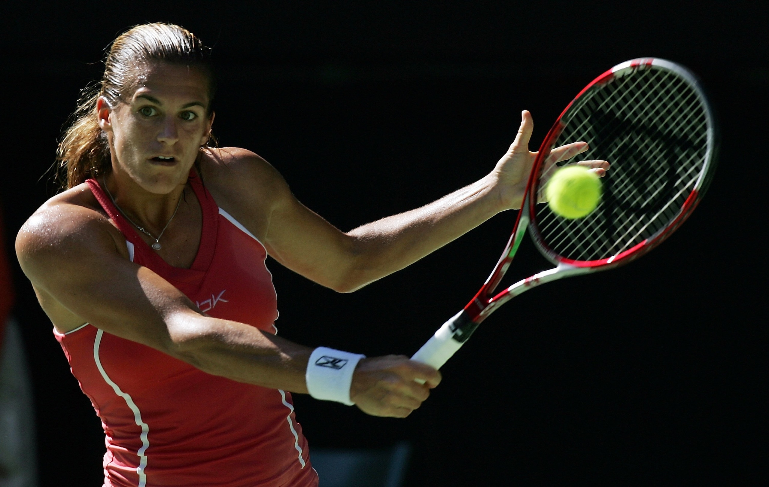 MELBOURNE, AUSTRALIA - JANUARY 25: Amelie Mauresmo of France plays a backhand in her quarter-final match against Patty Schnyder of Switerland during day ten of the Australian Open at Melbourne Park January 25, 2006 in Melbourne, Australia. (Photo by Phil