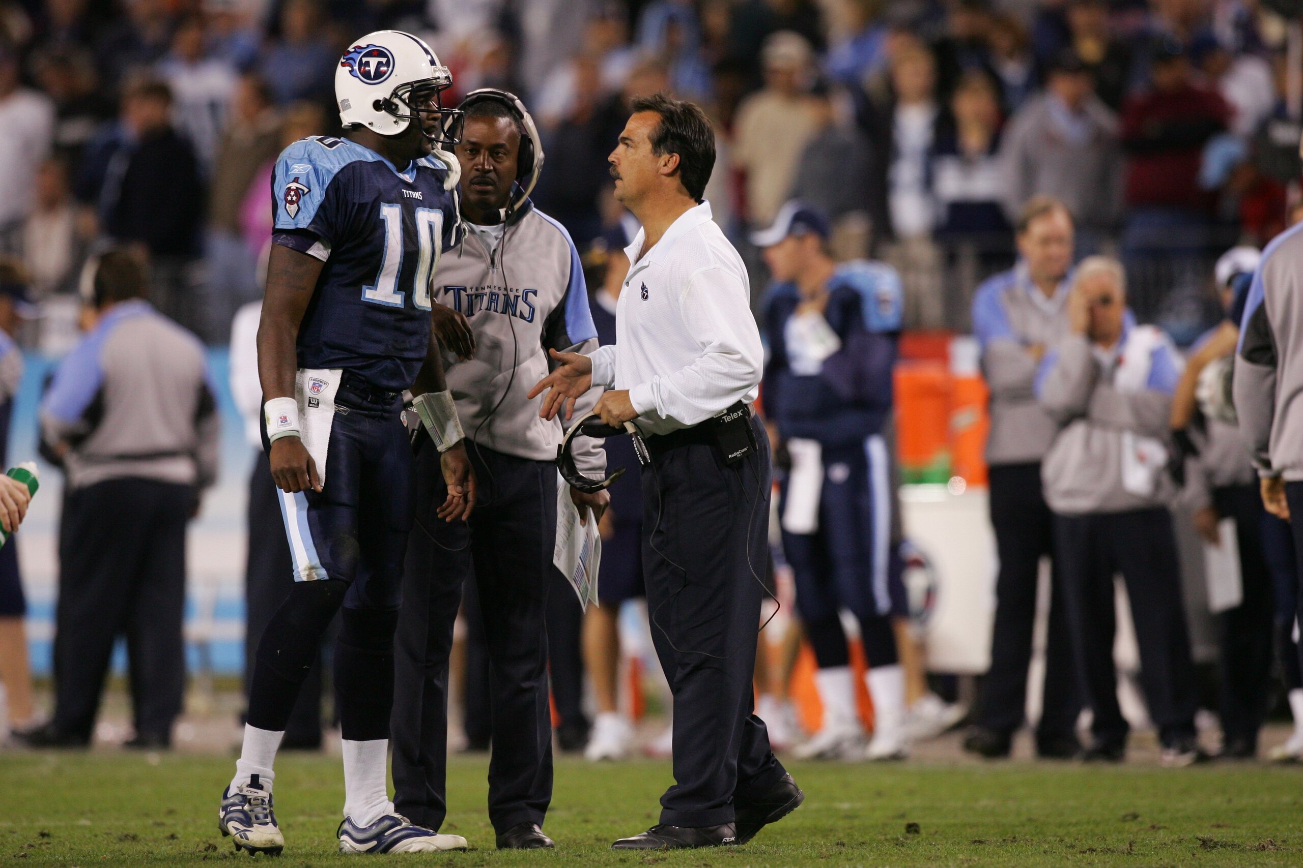 NASHVILLE, TN - NOVEMBER 26:  Head coach Jeff Fisher of the Tennessee Titans talks to quarterback Vince Young #10 as quarterbacks coach Craig Johnson looks on against the New York Giants at LP Field on November 26, 2006 in Nashville, Tennessee. The Titans