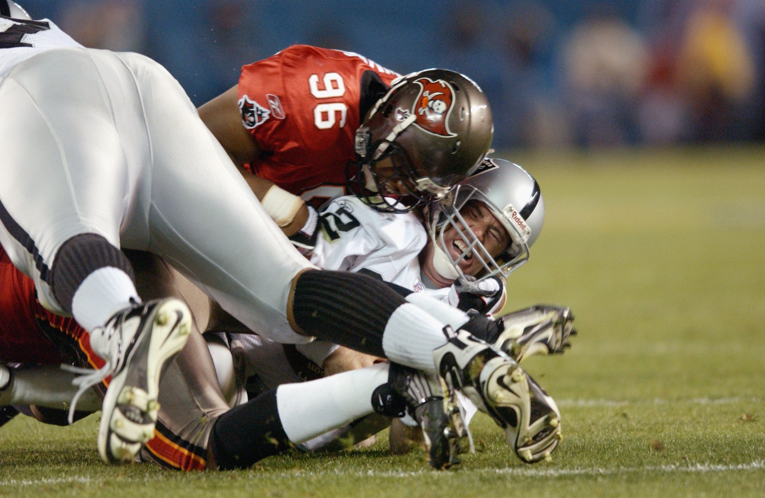 SAN DIEGO - JANUARY 26:  Ellis Wyms #96 of the Tampa Bay Buccaneers sacks quarterback Rich Gannon #12 of the Oakland Raiders for a one yard loss at the Oakland 17 yardline at 4:41 of the third quarter of Super Bowl XXXVII on January 26, 2003 at Qualcomm S