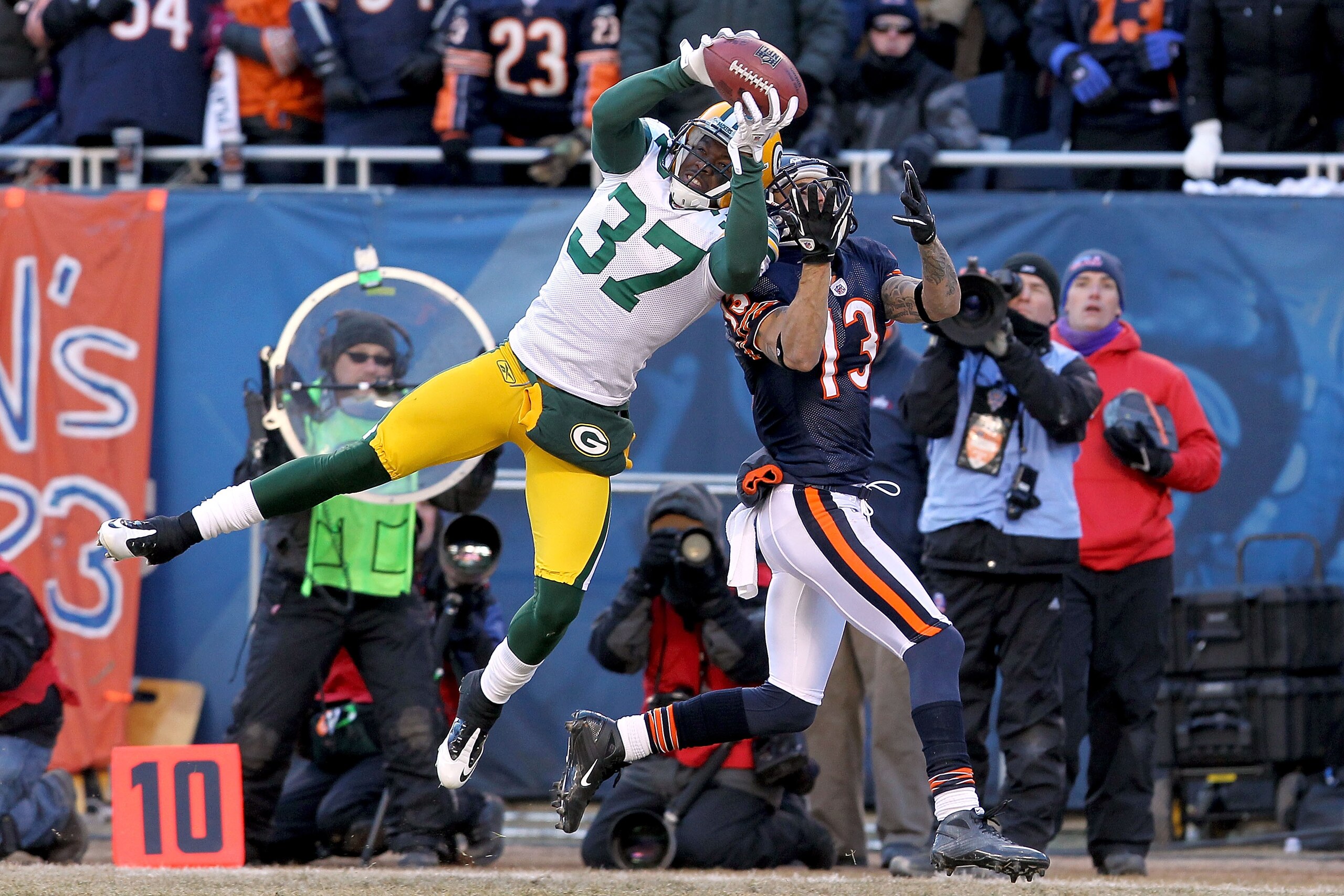CHICAGO, IL - JANUARY 23:  Sam Shields #37 of the Green Bay Packers intercepts a pass intended for Johnny Knox #13 of the Chicago Bears late in the second quarter in the NFC Championship Game at Soldier Field on January 23, 2011 in Chicago, Illinois.  (Ph