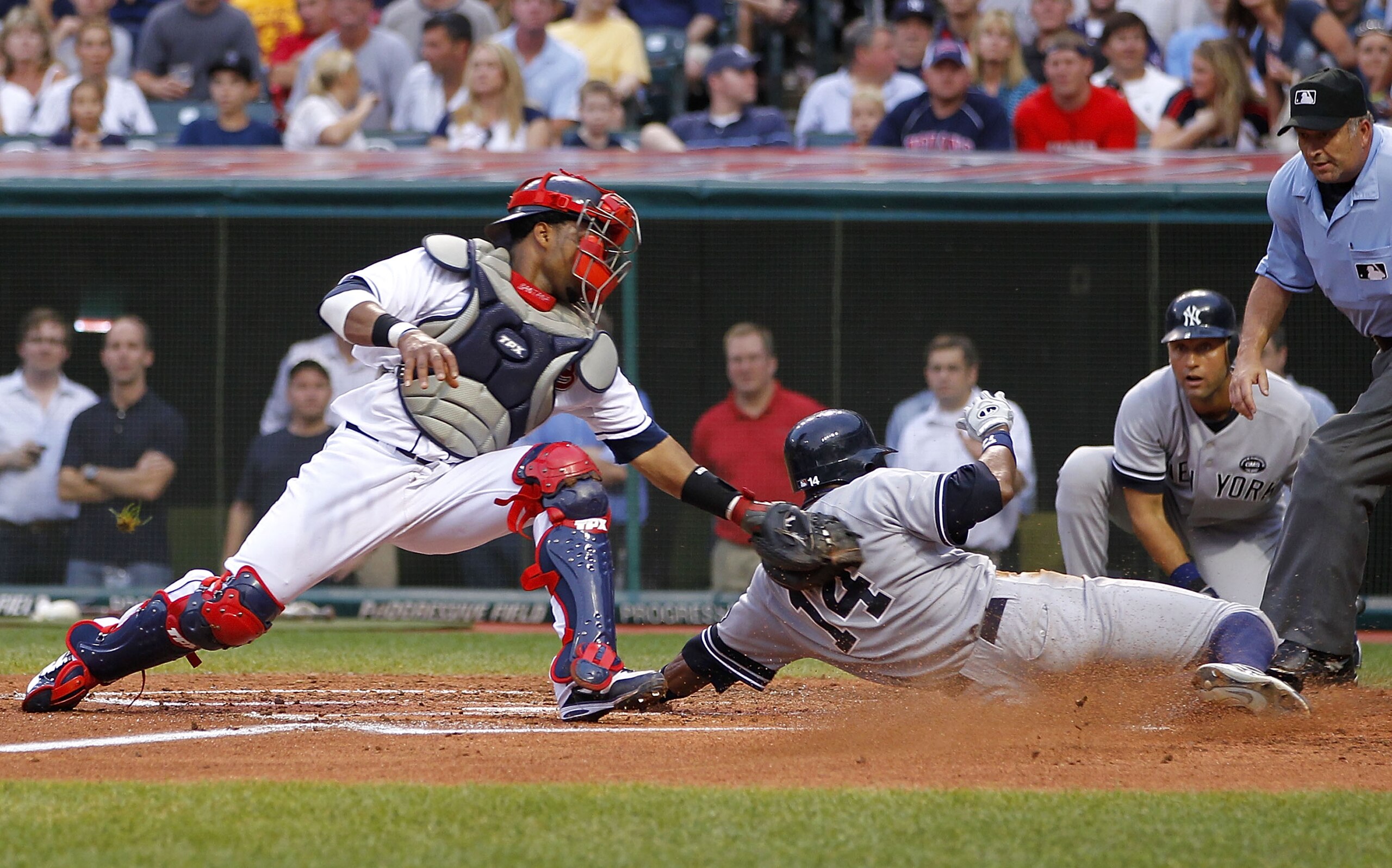 CLEVELAND - JULY 28: Curtis Granderson #14 of the New York Yankees beats the tag by Carlos Santana #41 of the Cleveland Indians to score a second inning run on July 28, 2010 at Progressive Field in Cleveland, Ohio. (Photo by Gregory Shamus/Getty Images) CLEVELAND - JULY 28: Curtis Granderson #14 of the New York Yankees beats the tag by Carlos Santana #41 of the Cleveland Indians to score a second inning run on July 28, 2010 at Progressive Field in Cleveland, Ohio. (Photo by Gregory Shamus/Getty Images)