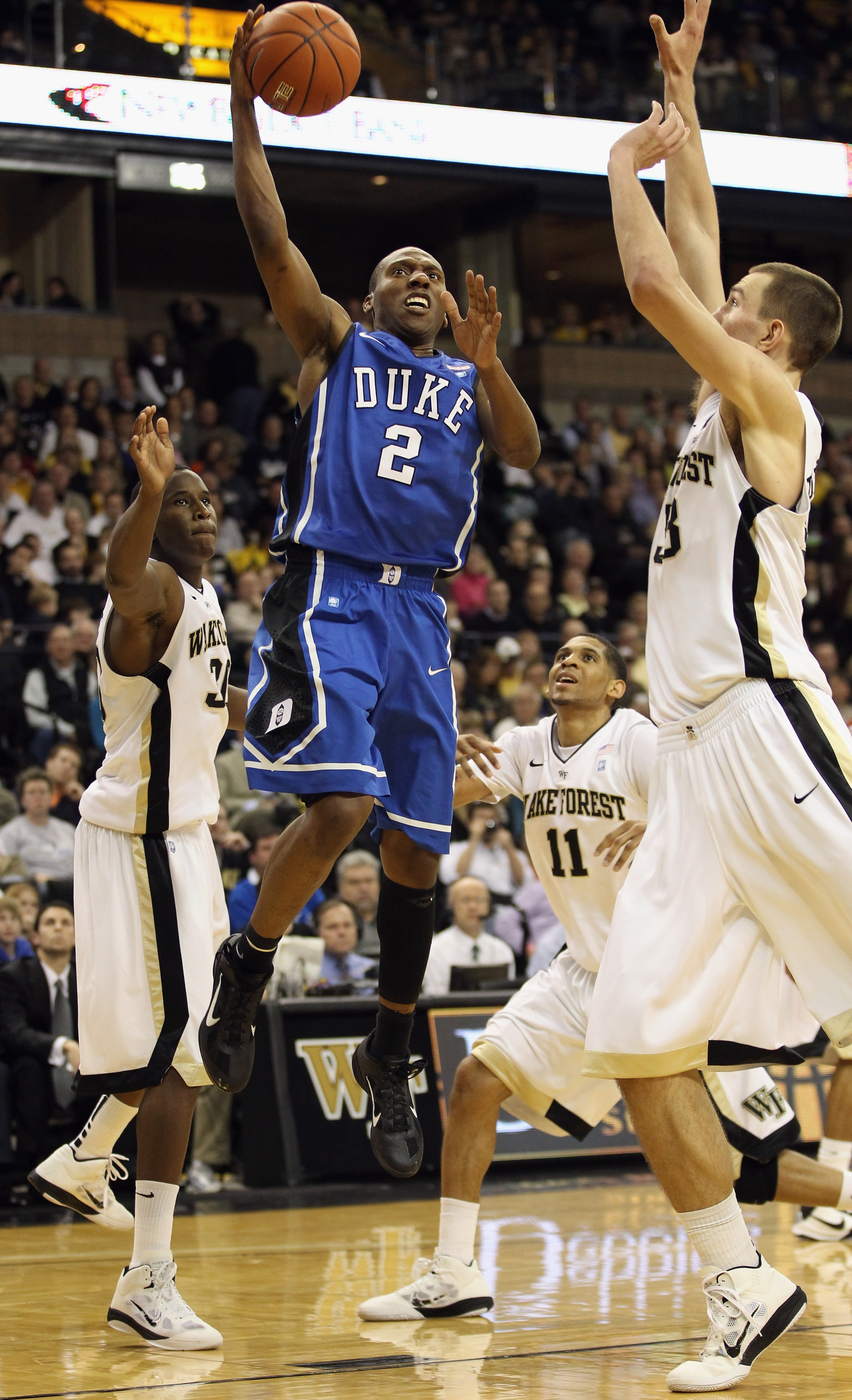 WINSTON SALEM, NC - JANUARY 22: Nolan Smith #2 of the Duke Blue Devils drives to the basket on the defense of the Wake Forest Demon Deacons during their game at Lawrence Joel Coliseum on January 22, 2011 in Winston Salem, North Carolina. (Photo by Stree WINSTON SALEM, NC - JANUARY 22: Nolan Smith #2 of the Duke Blue Devils drives to the basket on the defense of the Wake Forest Demon Deacons during their game at Lawrence Joel Coliseum on January 22, 2011 in Winston Salem, North Carolina. (Photo by Stree