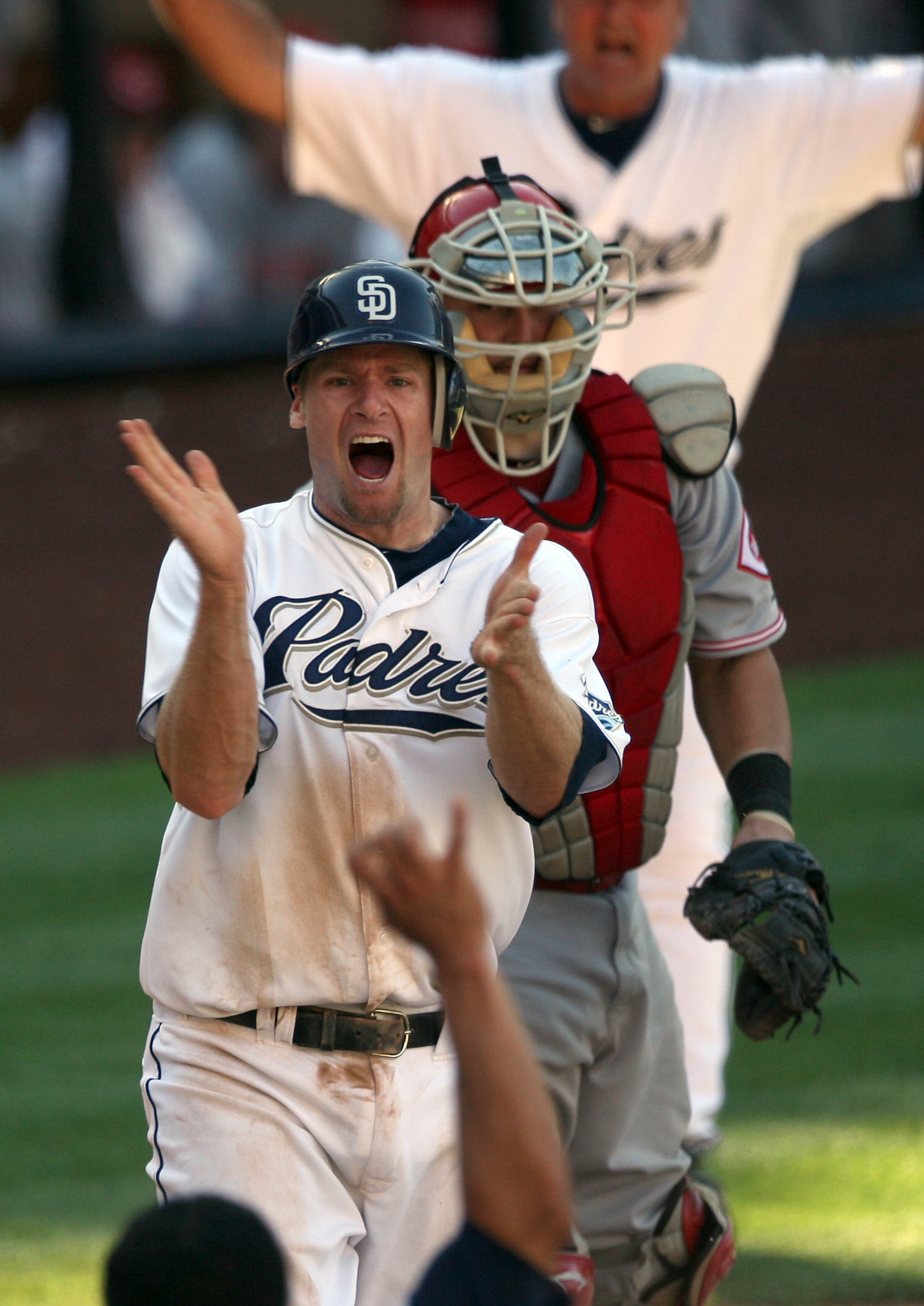 SAN DIEGO, CA - SEPTEMBER 25: Chase Headley #7 of the San Diego Padres slides past the tag of catcher Ramon Hernandez #55 of the Cincinnati Reds for the winning score during the Padres 4-3 win in their MLB game on September 25, 2010 at PETCO Park in San SAN DIEGO, CA - SEPTEMBER 25: Chase Headley #7 of the San Diego Padres slides past the tag of catcher Ramon Hernandez #55 of the Cincinnati Reds for the winning score during the Padres 4-3 win in their MLB game on September 25, 2010 at PETCO Park in San