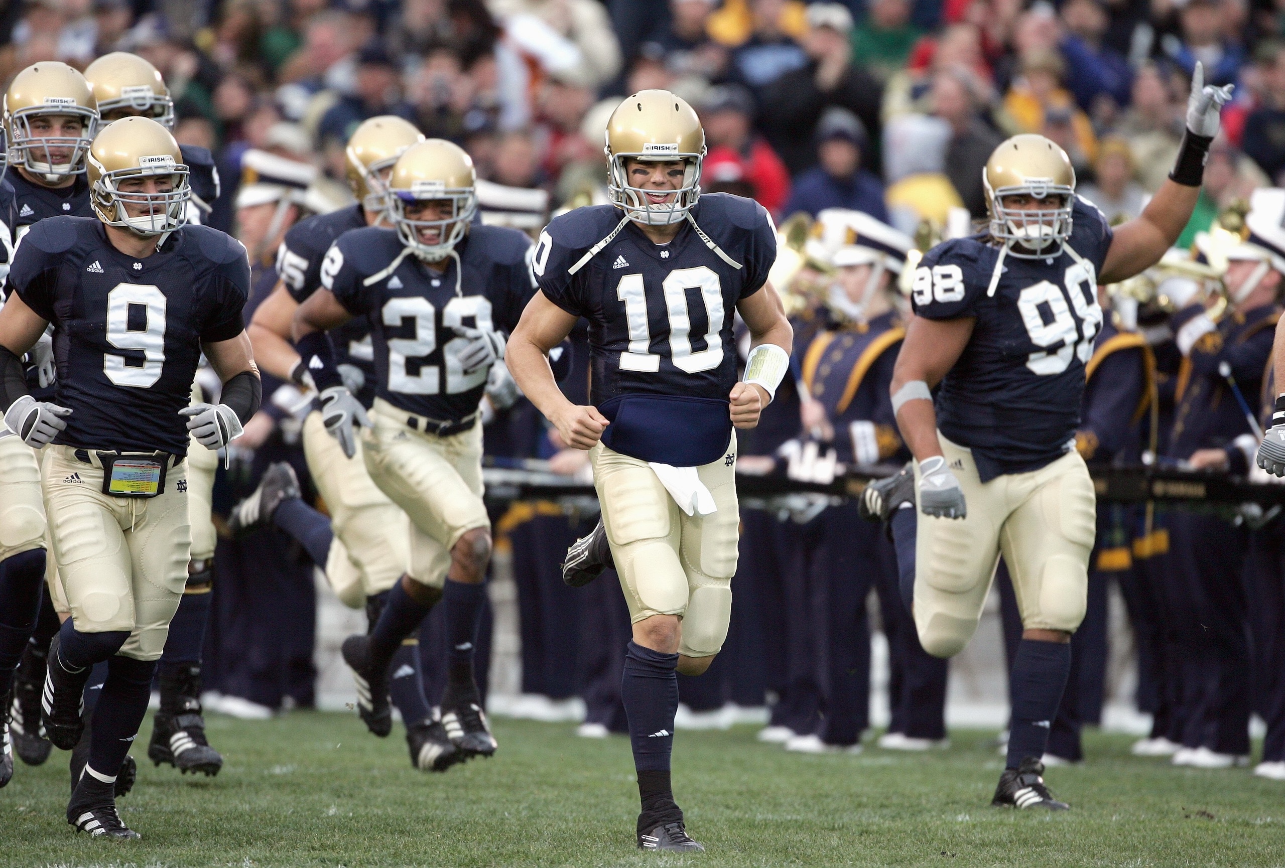 SOUTH BEND, IN - NOVEMBER 4: Quarterback Brady Quinn #10 and Tom Zbikowski #9 of the Notre Dame Fighting Irish run onto the field before the game against the North Carolina Tar Heels on November 4, 2006 at Notre Dame Stadium in South Bend, Indiana. (Photo
