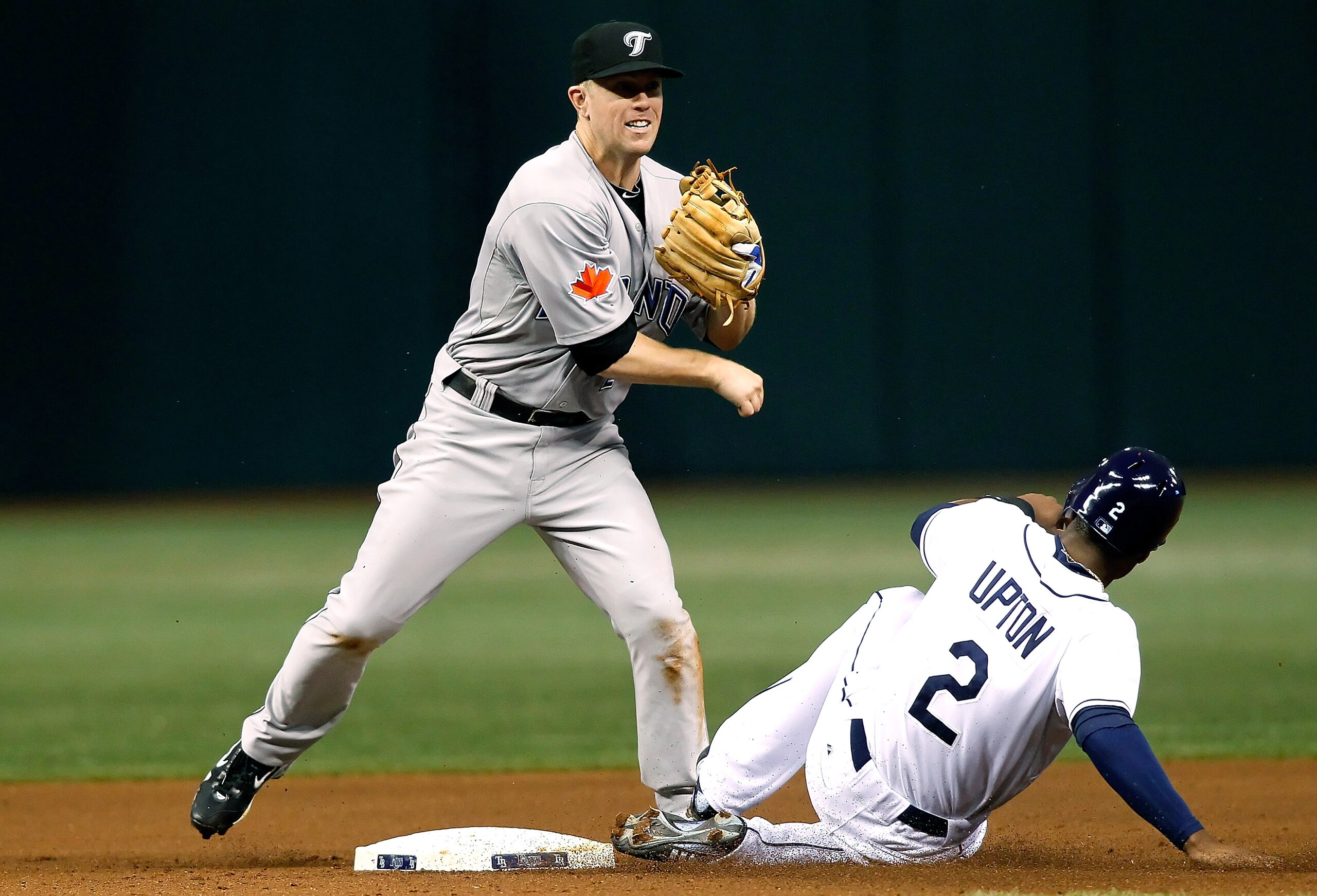 ST. PETERSBURG, FL - AUGUST 31: Infielder Aaron Hill #2 of the Toronto Blue Jays turns a double play as outfielder B.J. Upton #2 of the Tampa Bay Rays tries to break it up during the game at Tropicana Field on August 31, 2010 in St. Petersburg, Florida. ST. PETERSBURG, FL - AUGUST 31: Infielder Aaron Hill #2 of the Toronto Blue Jays turns a double play as outfielder B.J. Upton #2 of the Tampa Bay Rays tries to break it up during the game at Tropicana Field on August 31, 2010 in St. Petersburg, Florida.