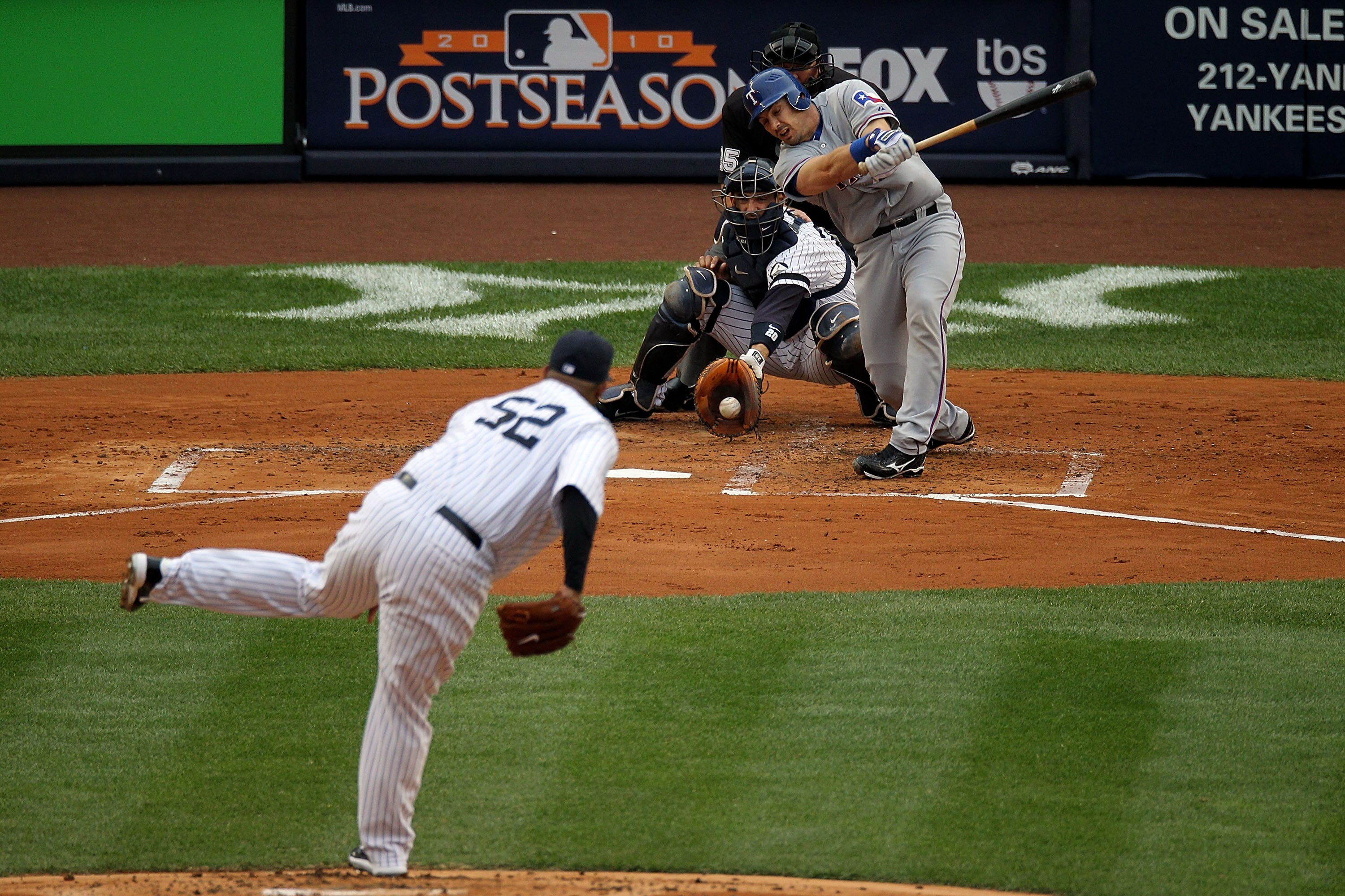 NEW YORK - OCTOBER 20:  CC Sabathia #52 of the New York Yankees strikes out Matt Treanor #15 of the Texas Rangers in Game Five of the ALCS during the 2010 MLB Playoffs at Yankee Stadium on October 20, 2010 in the Bronx borough of New York City.  (Photo by