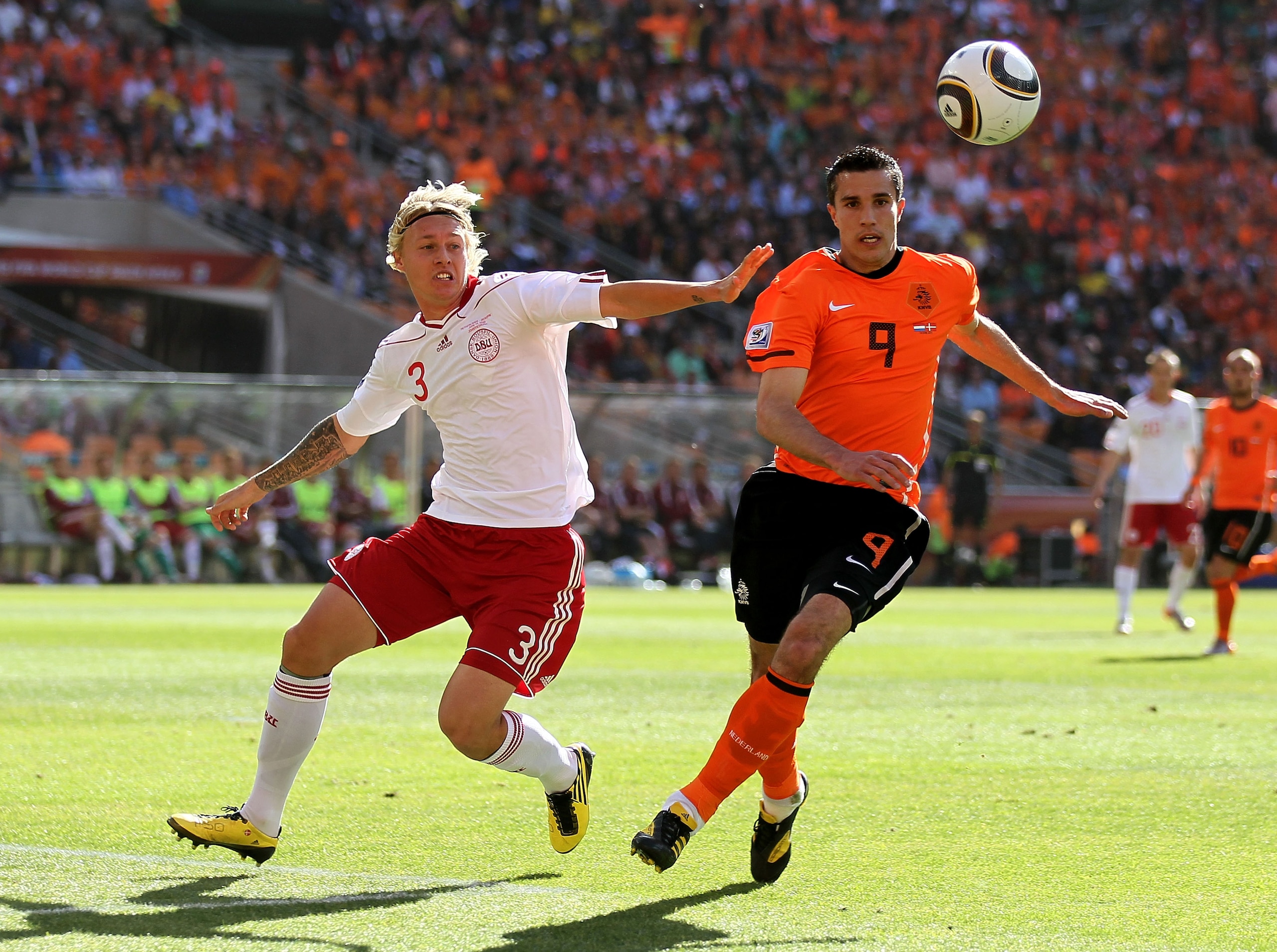 JOHANNESBURG, SOUTH AFRICA - JUNE 14: Simon Kjaer of Denmark challenges Robin Van Persie of the Netherlands during the 2010 FIFA World Cup Group E match between Netherlands and Denmark at Soccer City Stadium on June 14, 2010 in Johannesburg, South Africa.
