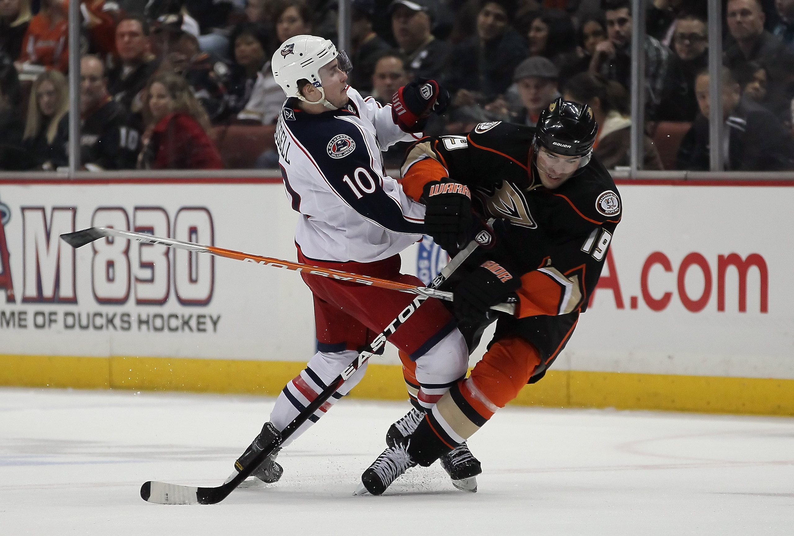 ANAHEIM, CA - JANUARY 07:  Joffrey Lupul #19 of the Anaheim Ducks is hit by Kris Russel #10 of the Columbus Blue Jackets in the third period at the Honda Center on January 7, 2011 in Anaheim, California. The Ducks defeated the Blue Jackets 6-0.  (Photo by