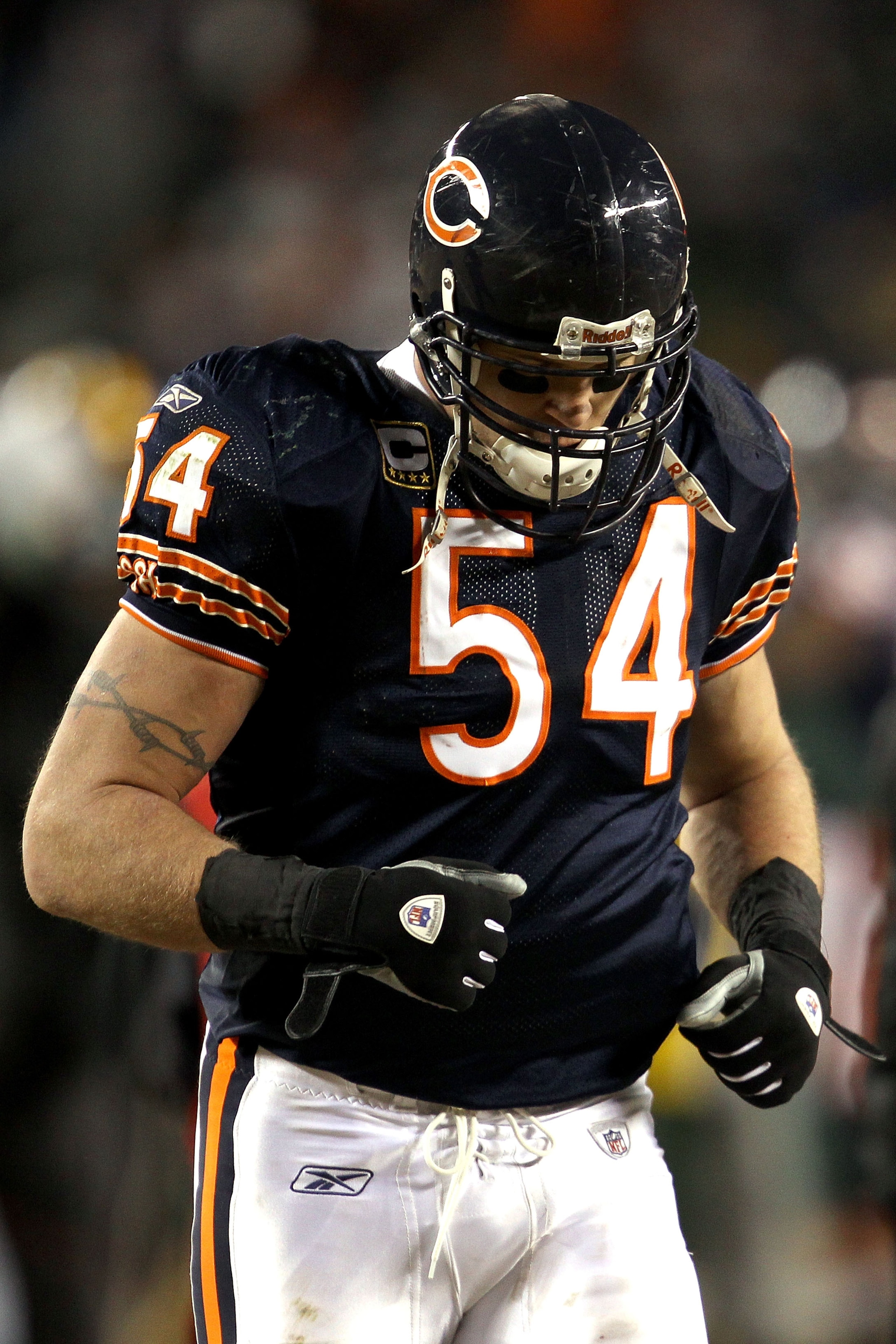 CHICAGO, IL - JANUARY 23:  Brian Urlacher #54 of the Chicago Bears runs off the field after the Bears 21-14 loss to the Green Bay Packers in the NFC Championship Game at Soldier Field on January 23, 2011 in Chicago, Illinois.  (Photo by Jonathan Daniel/Ge