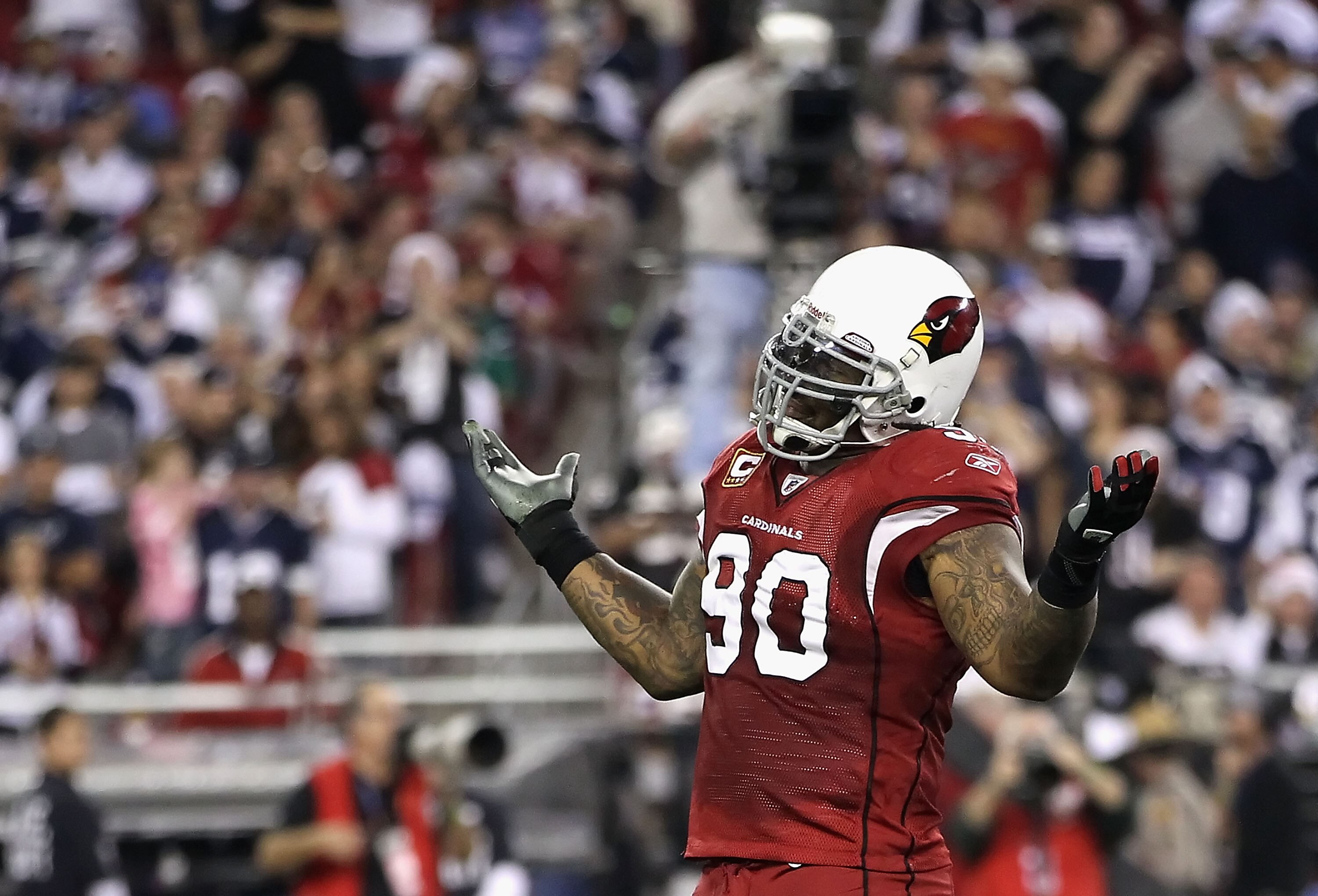 GLENDALE, AZ - DECEMBER 25:  Defensive tackle Darnell Dockett #90 of the Arizona Cardinals reacts after sacking quarterback Jon Kitna of the Dallas Cowboys (not picutred) during the second quarter of the NFL game at the University of Phoenix Stadium on De