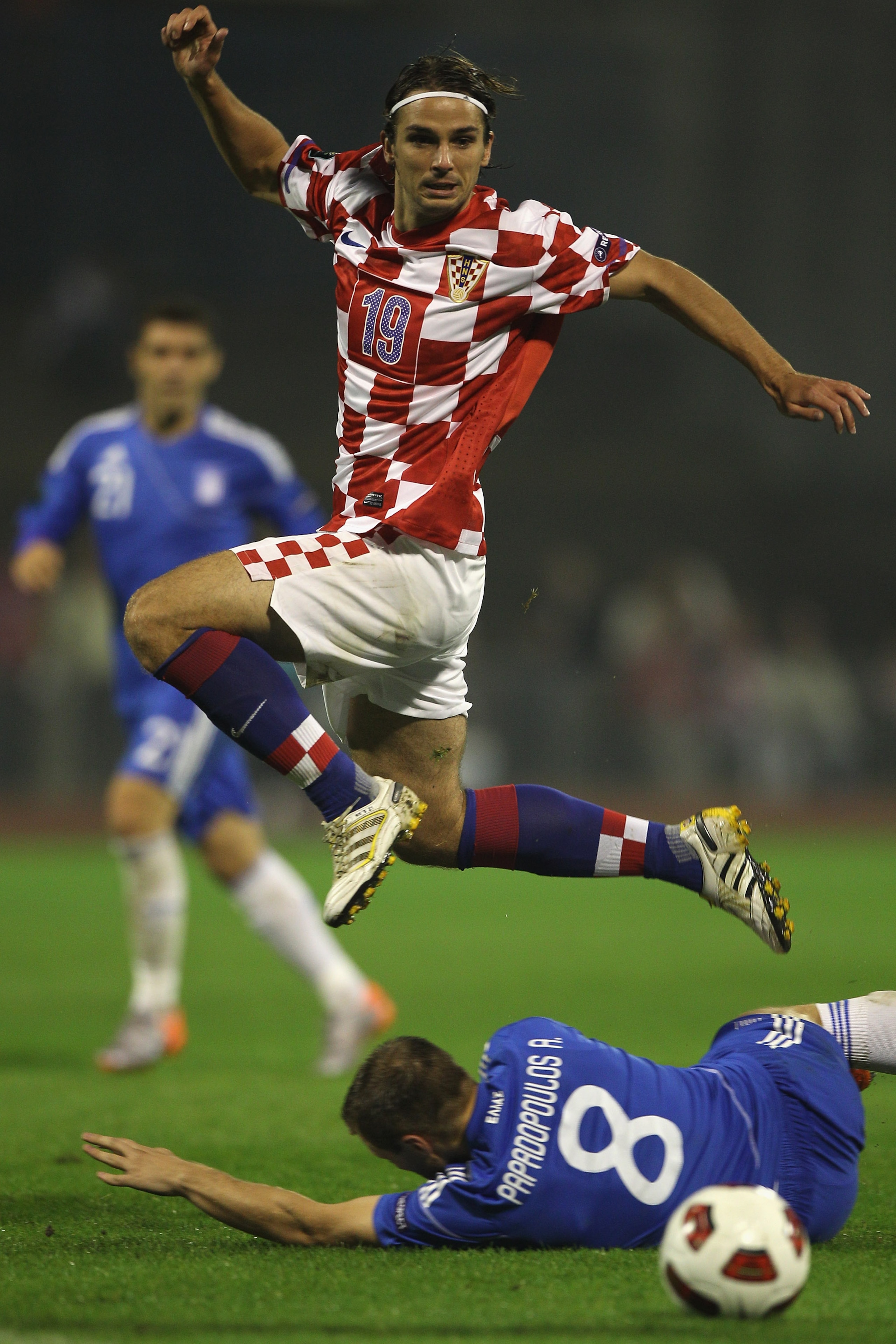 ZAGREB, CROATIA - SEPTEMBER 07: Niko Kranjcar of Croatia leaps the challenge of Avraam Papadopoulos during the EURO 2012 Qualifying Group F match between Croatia and Greece at the Stadion Maksimir on September 7, 2010 in Zagreb, Croatia. (Photo by Micha ZAGREB, CROATIA - SEPTEMBER 07: Niko Kranjcar of Croatia leaps the challenge of Avraam Papadopoulos during the EURO 2012 Qualifying Group F match between Croatia and Greece at the Stadion Maksimir on September 7, 2010 in Zagreb, Croatia. (Photo by Micha