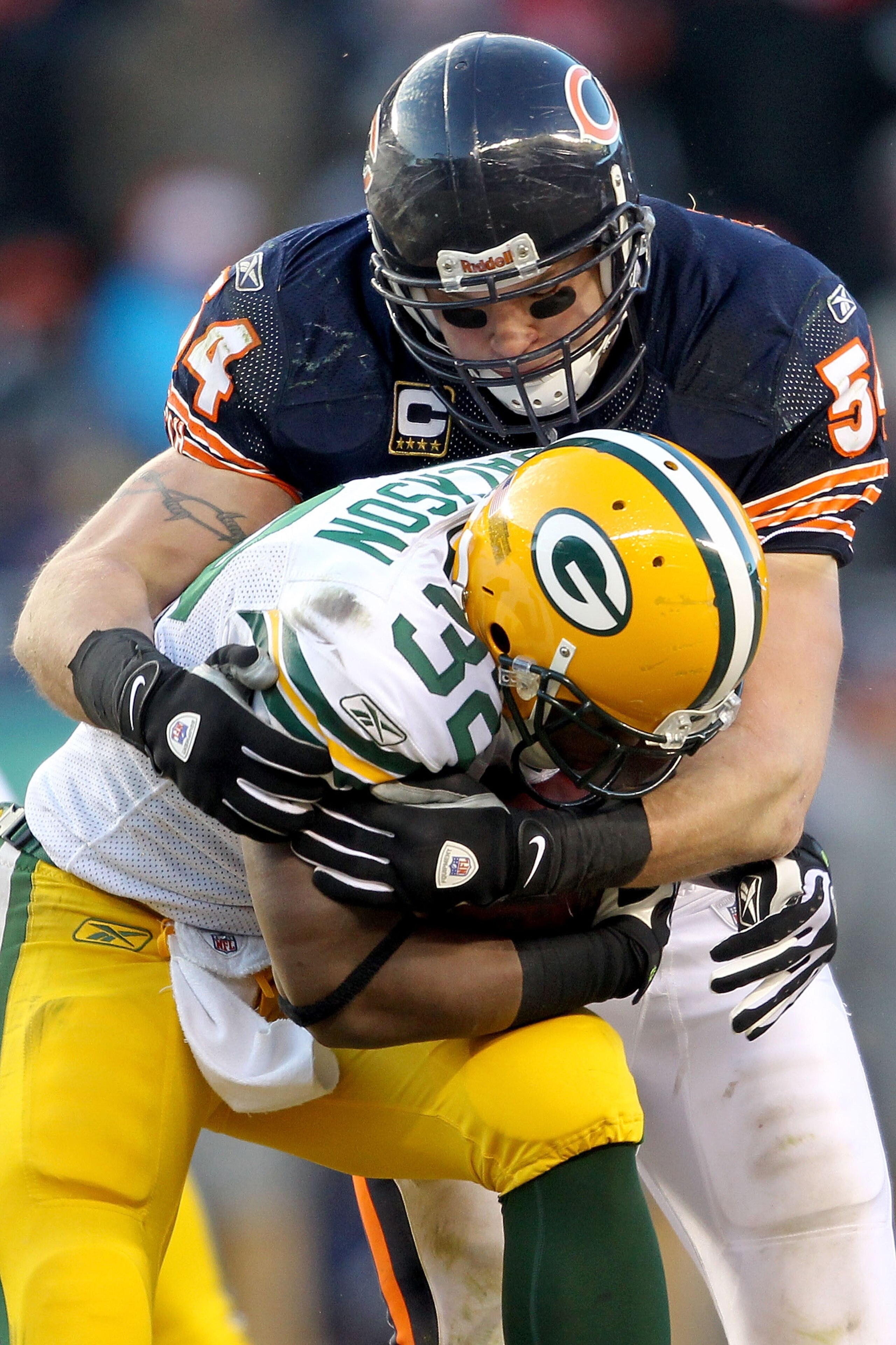 CHICAGO, IL - JANUARY 23:  Running back Brandon Jackson #32 of the Green Bay Packers is tackled by Brian Urlacher #54 of the Chicago Bears in the second half in the NFC Championship Game at Soldier Field on January 23, 2011 in Chicago, Illinois.  (Photo b