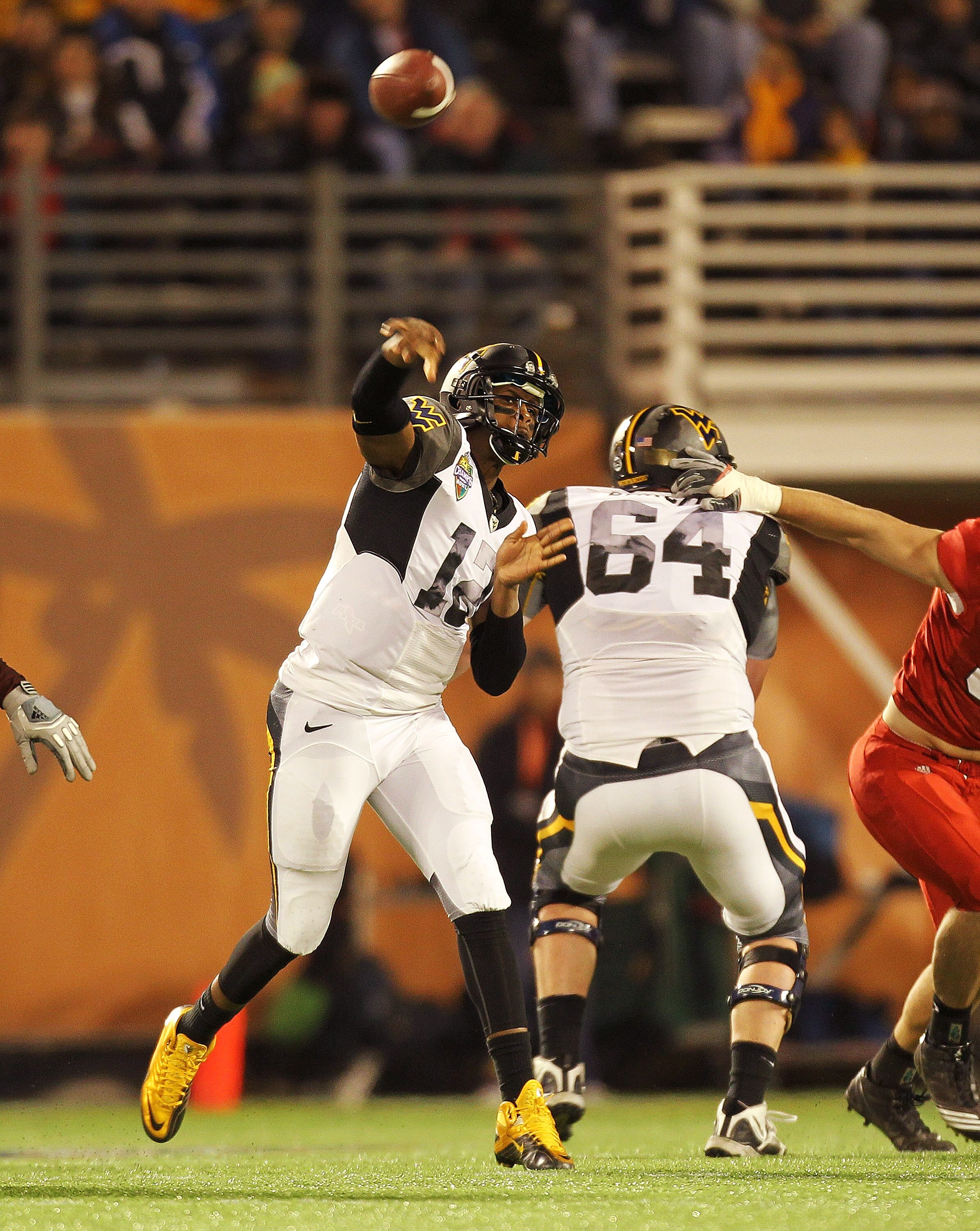 ORLANDO, FL - DECEMBER 28:  Geno Smith #12 of the West Virginia Mountineers passes the ball during the Champs Sports Bowl against the North Carolina State Wolfpack at Florida Citrus Bowl Stadium on December 28, 2010 in Orlando, Florida.  (Photo by Mike Eh