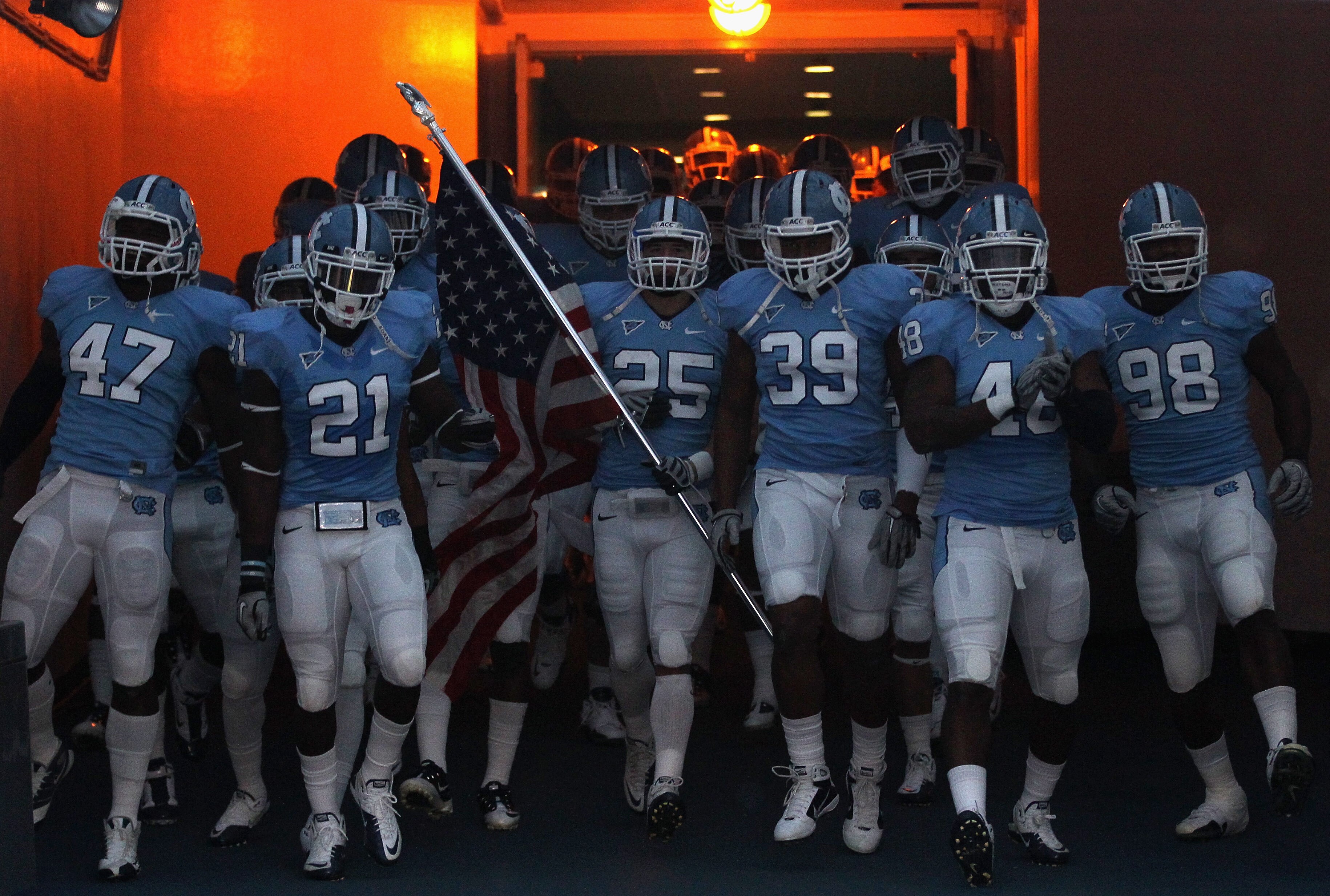 CHAPEL HILL, NC - NOVEMBER 13:  The North Carolina Tar Heels run onto the field before their game against the Virginia Tech Hokies at Kenan Stadium on November 13, 2010 in Chapel Hill, North Carolina.  (Photo by Streeter Lecka/Getty Images)