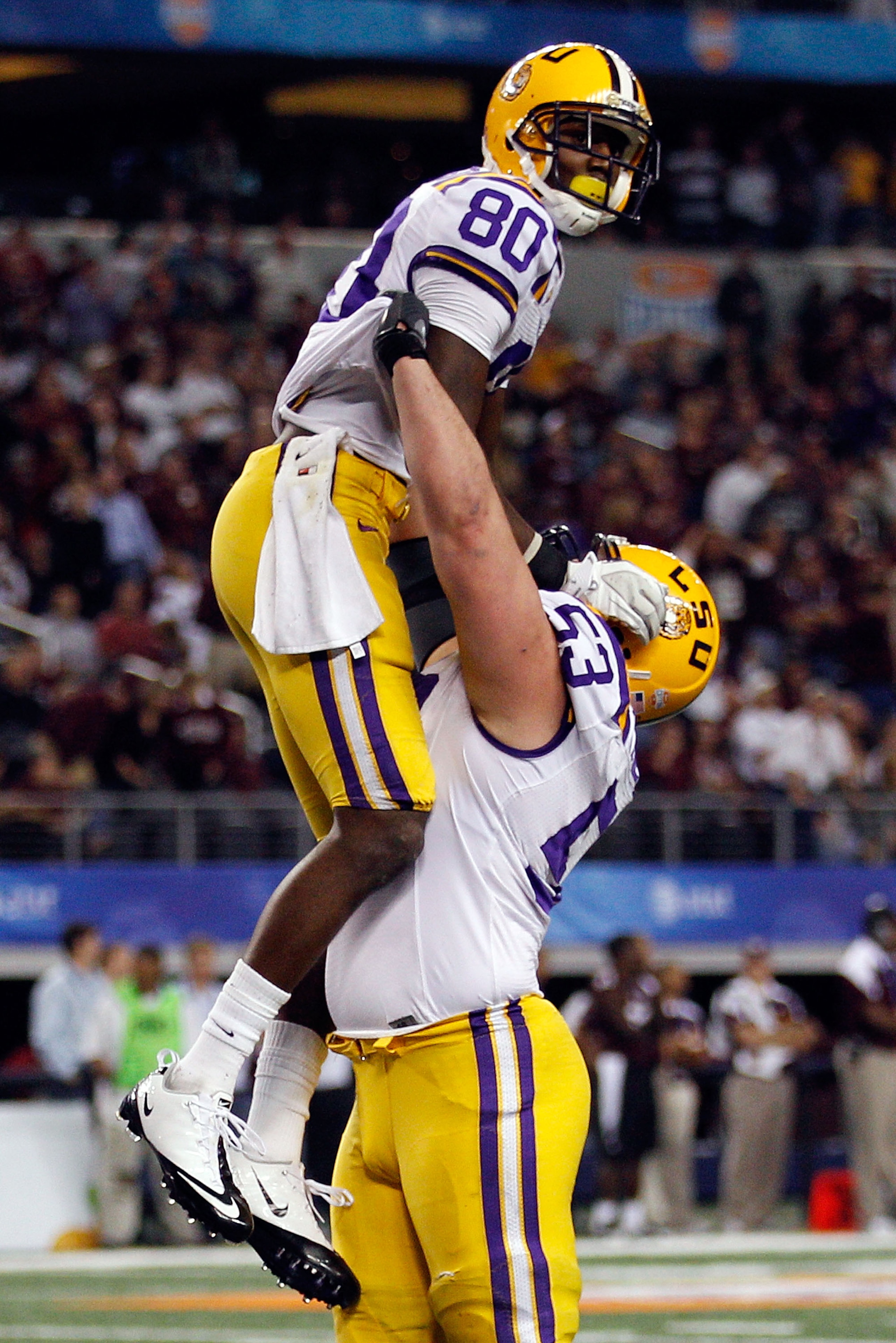 ARLINGTON, TX - JANUARY 07:  Terrence Toliver #80 and T-Bob Hebert #53 of the Louisiana State University Tigers celebrate after Toliver scored a touchdown against the Texas A&M Aggies during the AT&T Cotton Bowl at Cowboys Stadium on January 7, 2011 in Ar