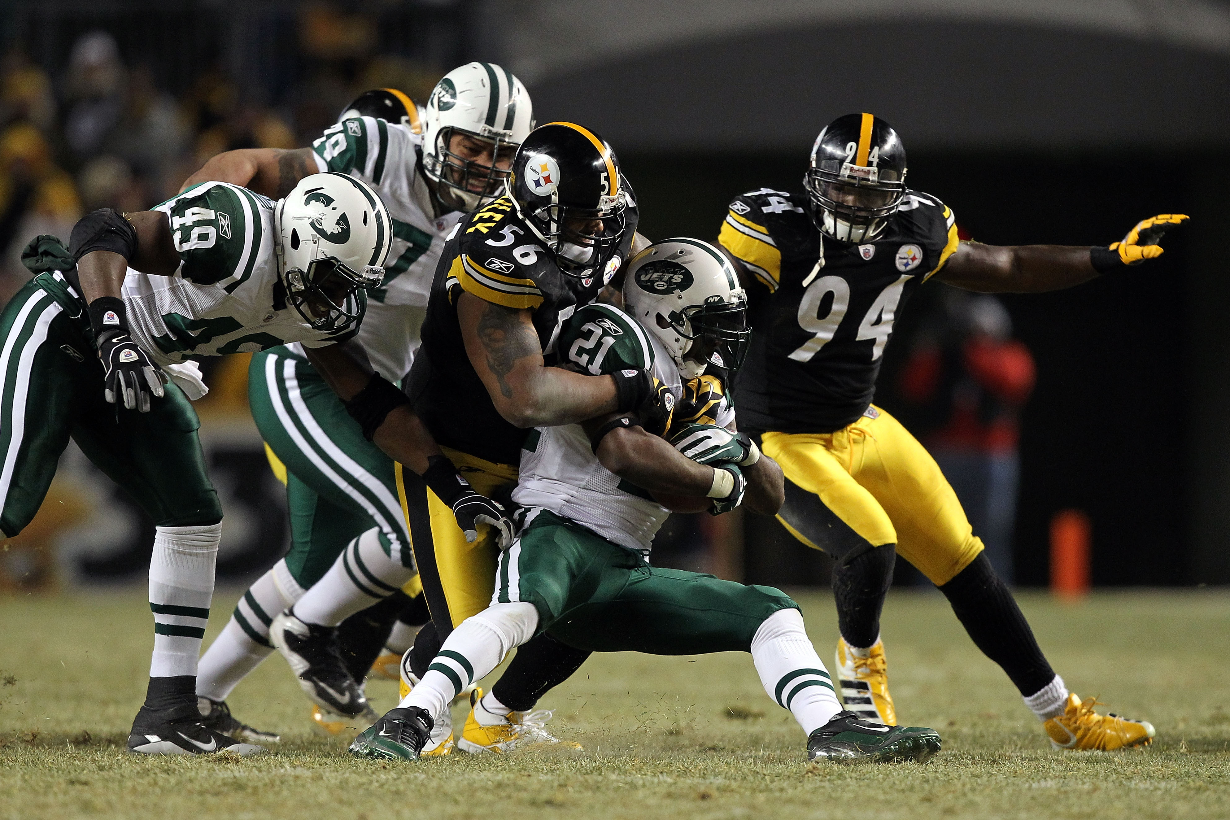 PITTSBURGH, PA - JANUARY 23:  LaDainian Tomlinson #21 of the New York Jets is brought down by LaMarr Woodley #56 of the Pittsburgh Steelers during the 2011 AFC Championship game at Heinz Field on January 23, 2011 in Pittsburgh, Pennsylvania.  (Photo by Al