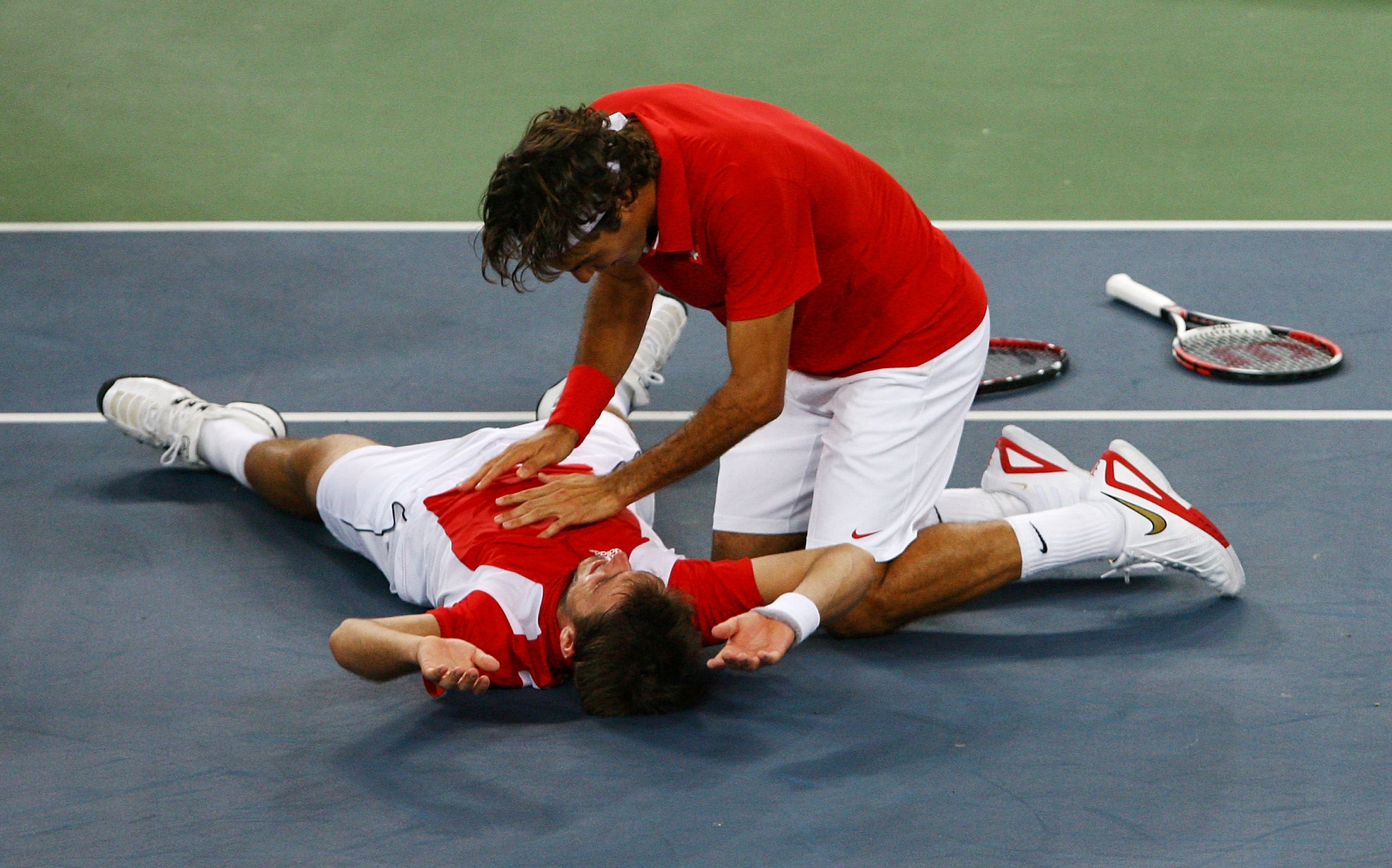 BEIJING - AUGUST 16:  Roger Federer (right) and Stanislas Wawrinka of Switzerland celebrate after defeating Thomas Johansson and Simon Aspelin of Sweden during the men's doubles gold medal tennis match at the Olympic Green Tennis Center on Day 8 of the Be