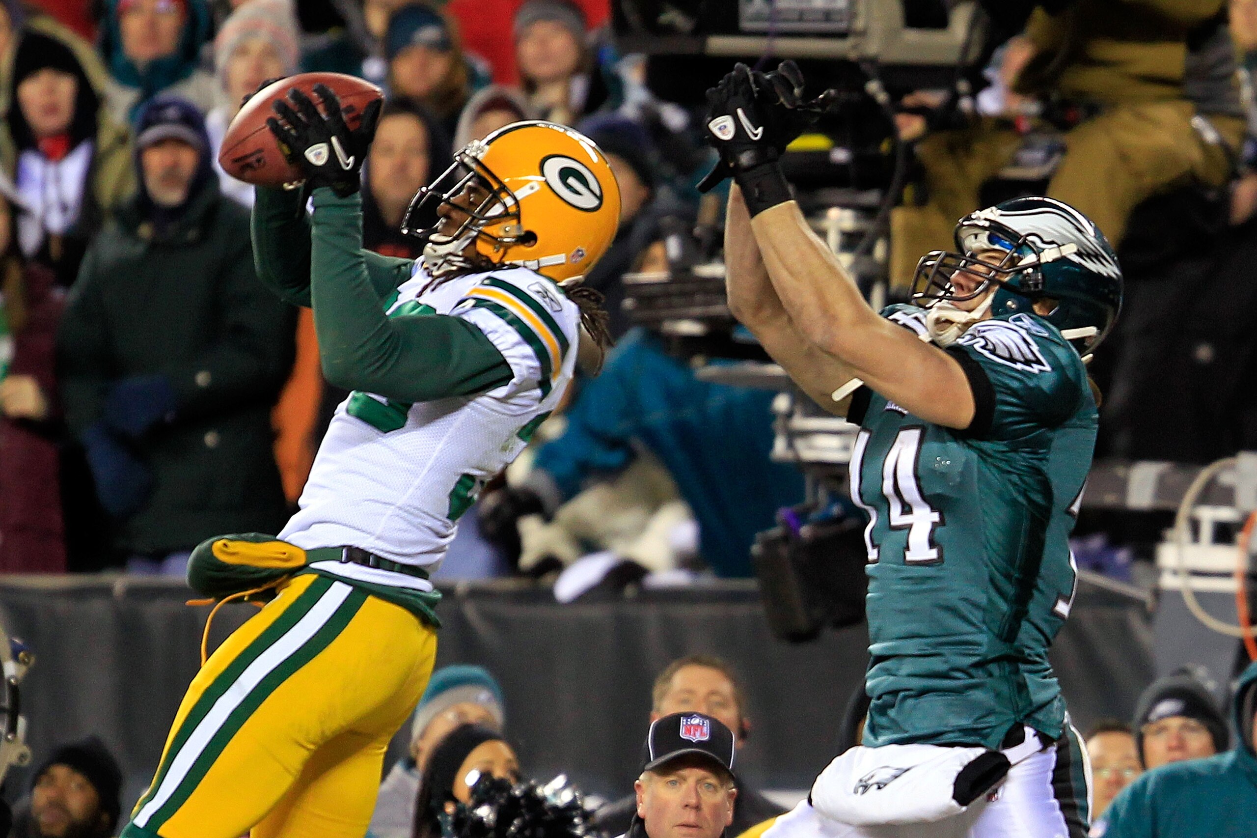 PHILADELPHIA, PA - JANUARY 09:  Tramon Williams #38 of the Green Bay Packers intercepts the pass intended for Riley Cooper #14 of the Philadelphia Eagles late in the fourth quarter during the 2011 NFC wild card playoff game at Lincoln Financial Field on J