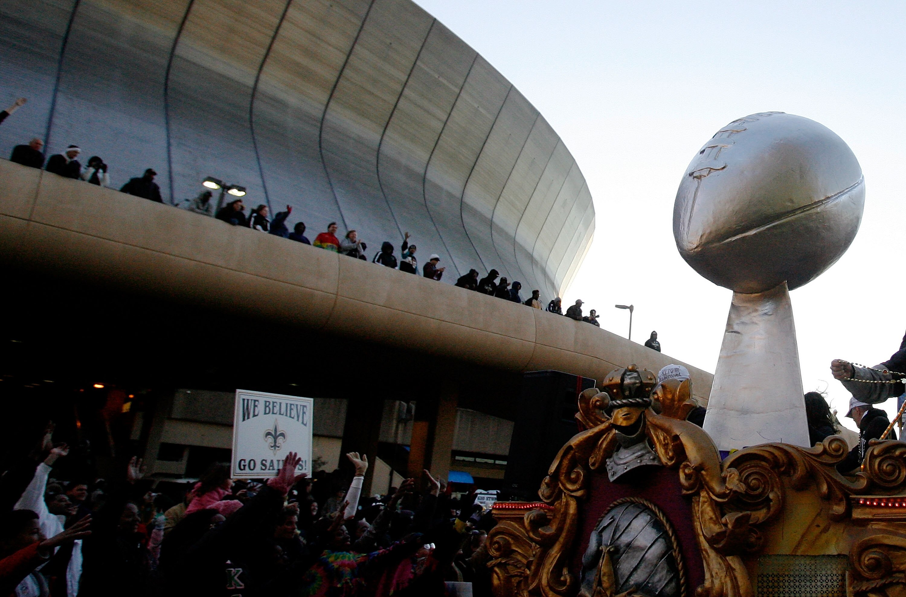 NEW ORLEANS - FEBRUARY 09: New Orleans Saints fans cheer on as their team passes in front of the Louisiana Superdome while parading though the city after winning the Super Bowl XLIV on February 9, 2010 in New Orleans, Louisiana. (Photo by Sean Gardner/Get