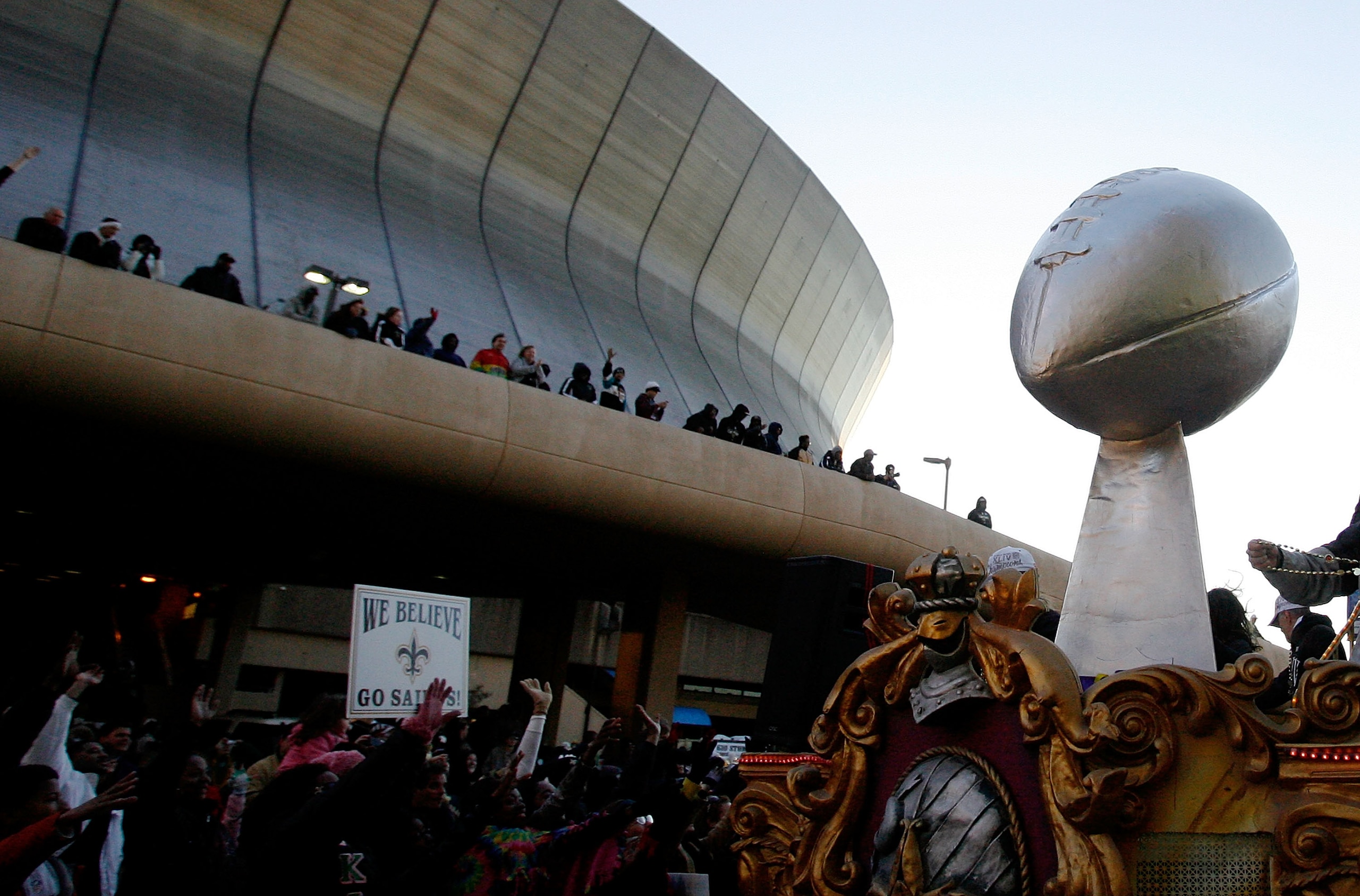 NEW ORLEANS - FEBRUARY 09: New Orleans Saints fans cheer on as their team passes in front of the Louisiana Superdome while parading though the city after winning the Super Bowl XLIV on February 9, 2010 in New Orleans, Louisiana. (Photo by Sean Gardner/Get