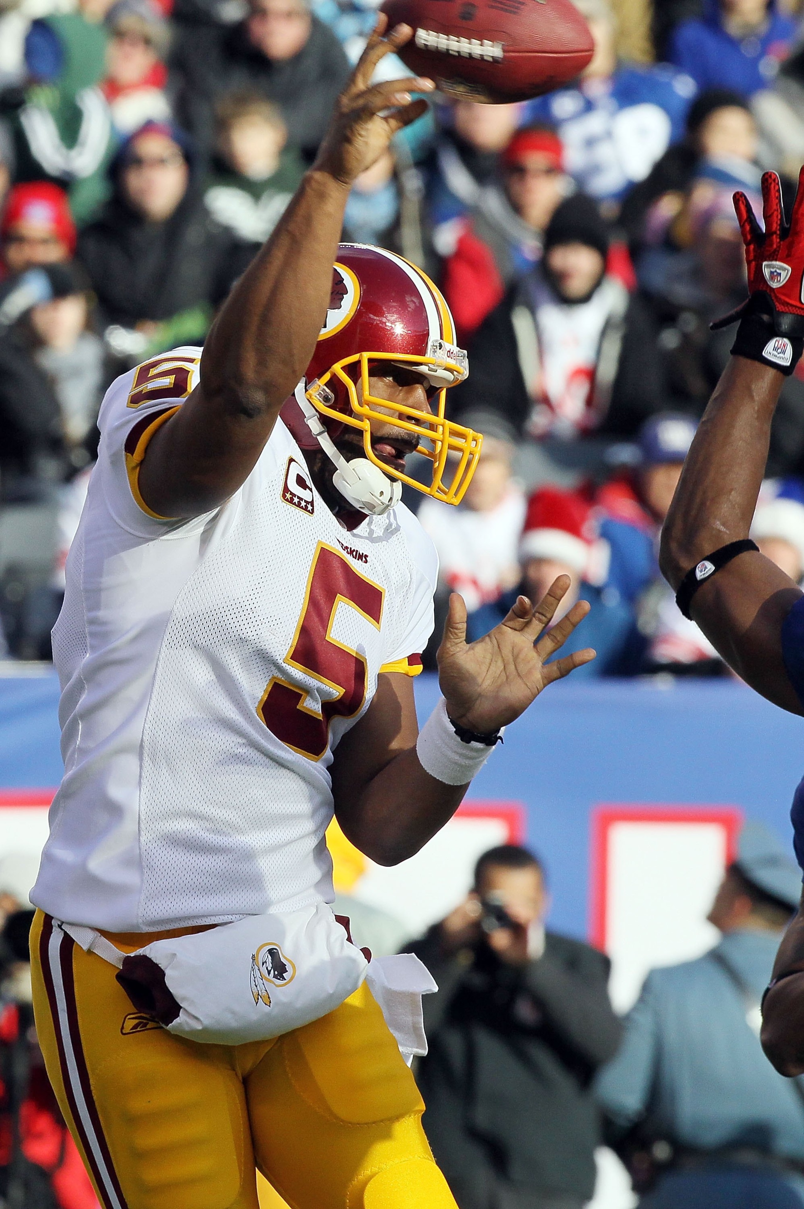 EAST RUTHERFORD, NJ - DECEMBER 05:  Donovan McNabb #5 of the Washington Redskins throws a pass against the New York Giants on December 5, 2010 at the New Meadowlands Stadium in East Rutherford, New Jersey. The Giants defeated the Redskins 31-7.  (Photo by