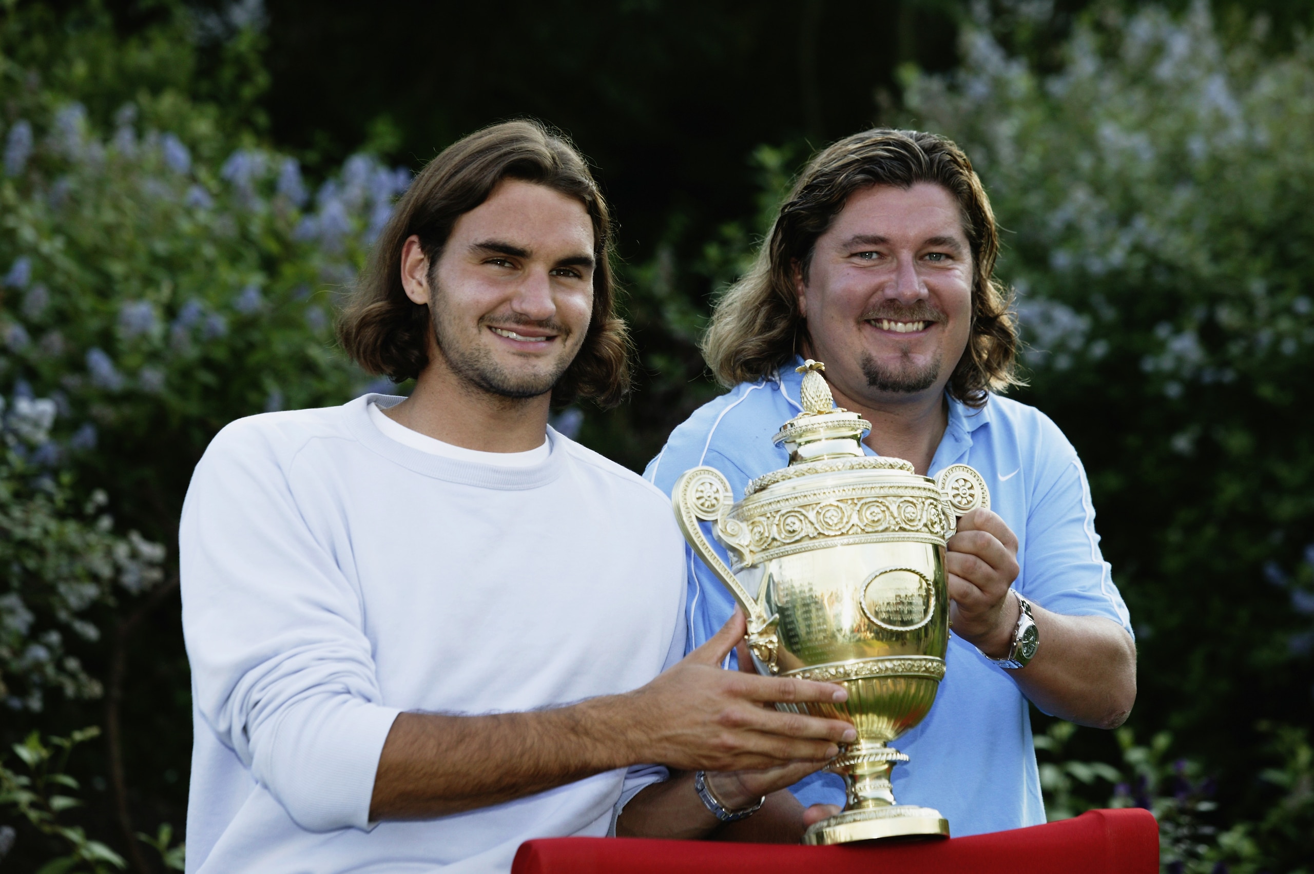 LONDON - JULY 6:  Men's Singles champion Roger Federer of Switzerland poses with the trophy with his coach Peter Lundgren during the final day of the Wimbledon Lawn Tennis Championships held on July 6, 2003 at the All England Lawn Tennis and Croquet Club,