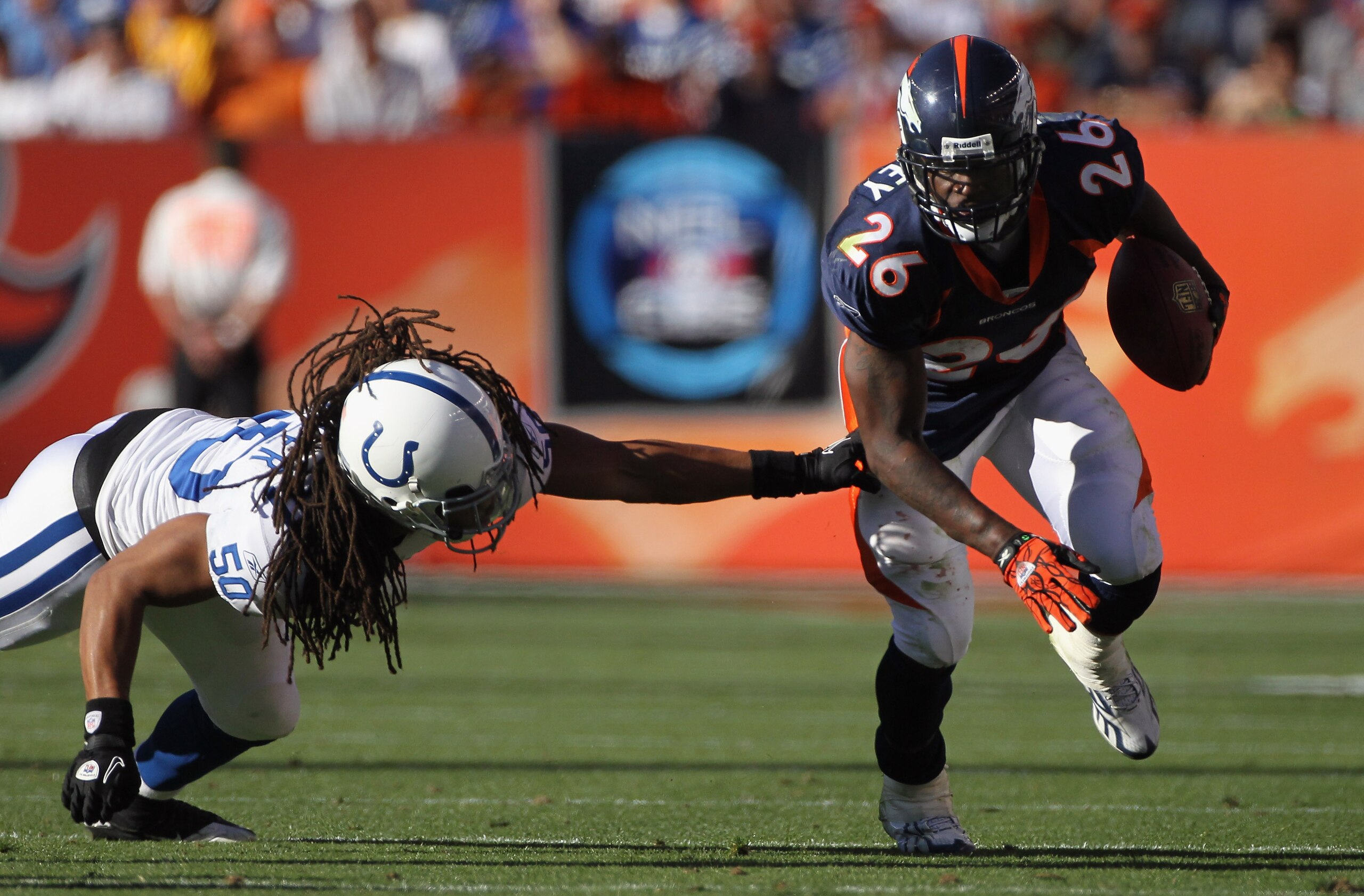 DENVER - SEPTEMBER 26: Running back Laurence Maroney #26 of the Denver Broncos eludes Philip Wheeler #50 of the Indianapolis Colts to pick up 26 yards and a first down on a screen pass at INVESCO Field at Mile High on September 26, 2010 in Denver, Colora DENVER - SEPTEMBER 26: Running back Laurence Maroney #26 of the Denver Broncos eludes Philip Wheeler #50 of the Indianapolis Colts to pick up 26 yards and a first down on a screen pass at INVESCO Field at Mile High on September 26, 2010 in Denver, Colora