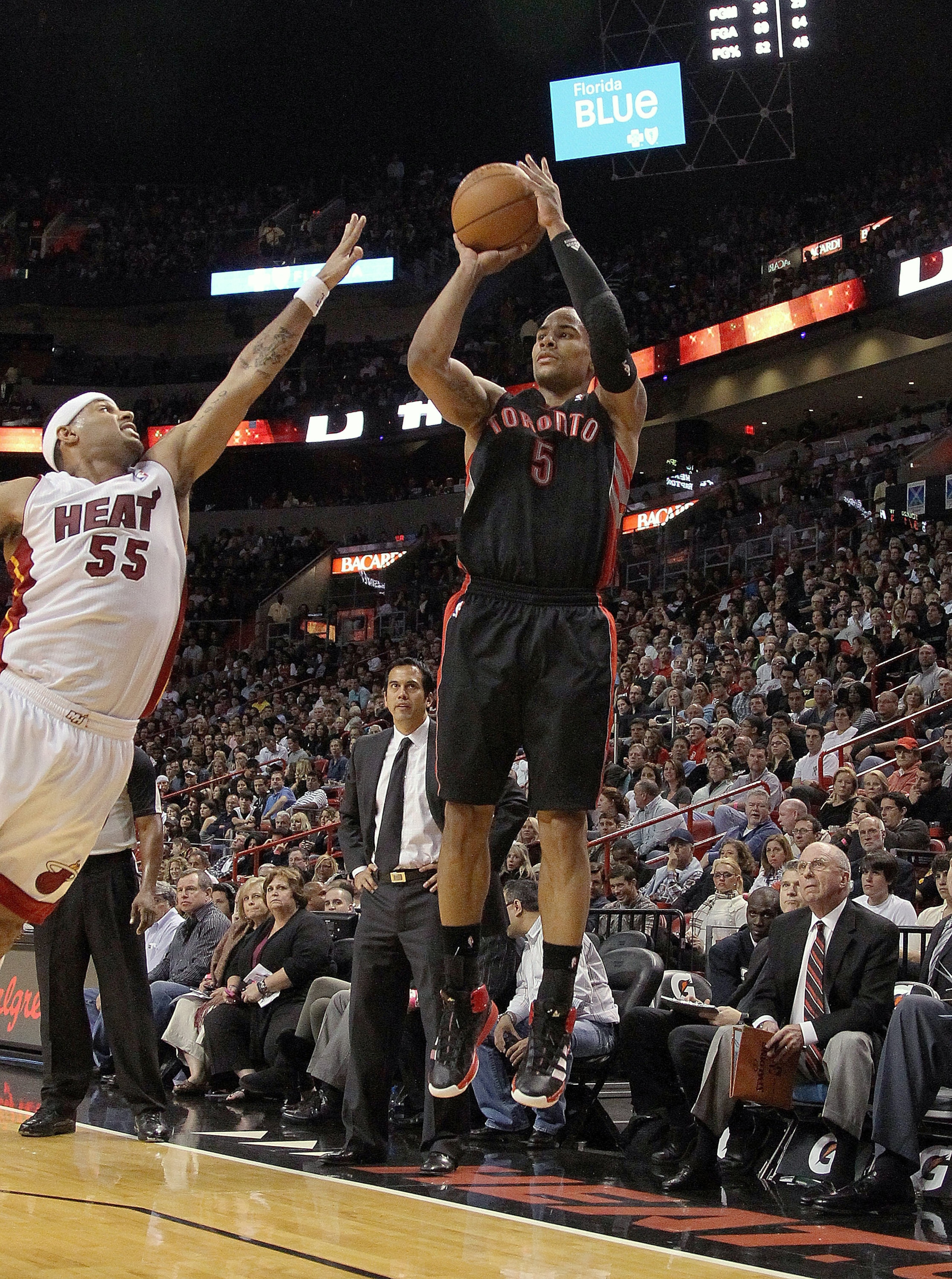 MIAMI, FL - JANUARY 22:  Jerryd Bayless #5 of the Toronto Raptors shoots over Eddie House #55 of the Miami Heat during a game at American Airlines Arena on January 22, 2011 in Miami, Florida. NOTE TO USER: User expressly acknowledges and agrees that, by d