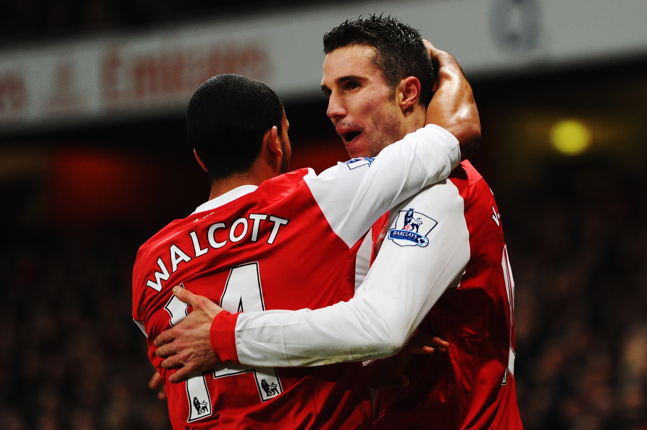 LONDON, UNITED KINGDOM - JANUARY 22:  Robin Van Persie (R) of Arsenal celebrates with team mate Theo Walcott (L) after scoring his third goal in a hat trick during the Barclays Premier League match between Arsenal and Wigan Athletic at the Emirates Stadiu