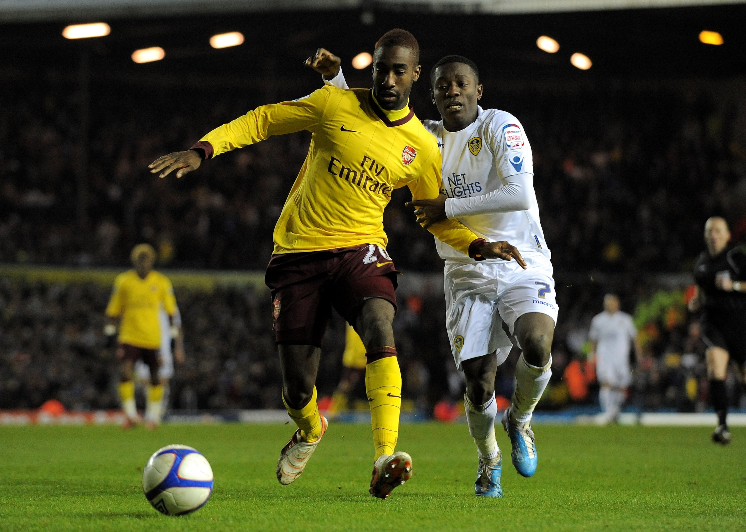 LEEDS, UNITED KINGDOM - JANUARY 19:  Johan Djourou of Arsenal tussles for posession with Max Gradel of Leeds United during the FA Cup sponsored by E.On Third Round Replay match between Leeds United and Arsenal at Elland Road on January 19, 2011 in Leeds,