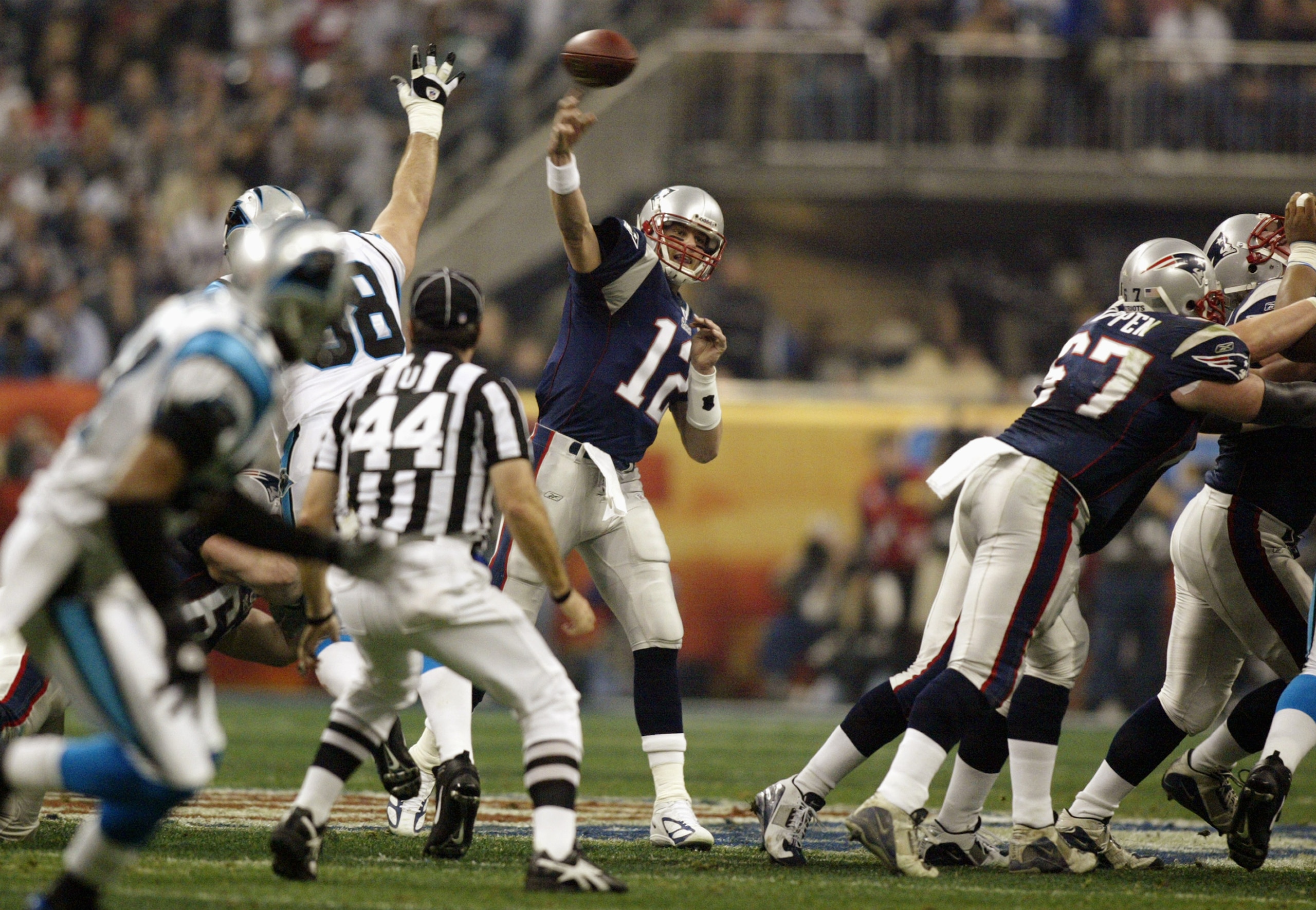 HOUSTON, TX - FEBRUARY 1:  Quarterback Tom Brady #12 of the New England Patriots throws the ball against the Carolina Panthers during Super Bowl XXXVIII at Reliant Stadium on February 1, 2004 in Houston, Texas. The Patriots won 32-29 to claim their second