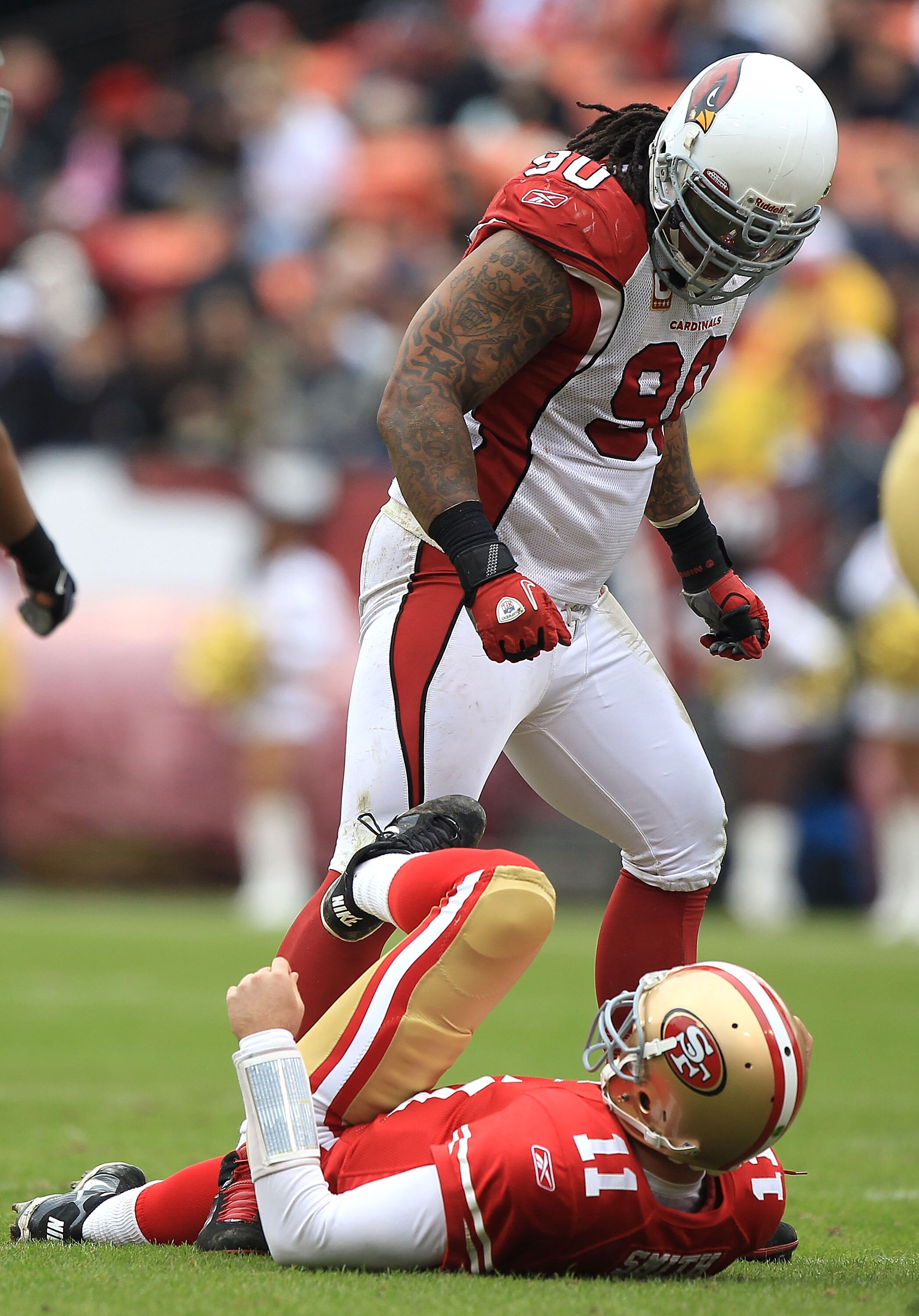 SAN FRANCISCO, CA - JANUARY 02:    Alex Smith #11 of the San Francisco 49ers is sacked by Darnell Dockett #90 of the Arizona Cardinals during an NFL game at Candlestick Park on January 2, 2011 in San Francisco, California.  (Photo by Jed Jacobsohn/Getty I