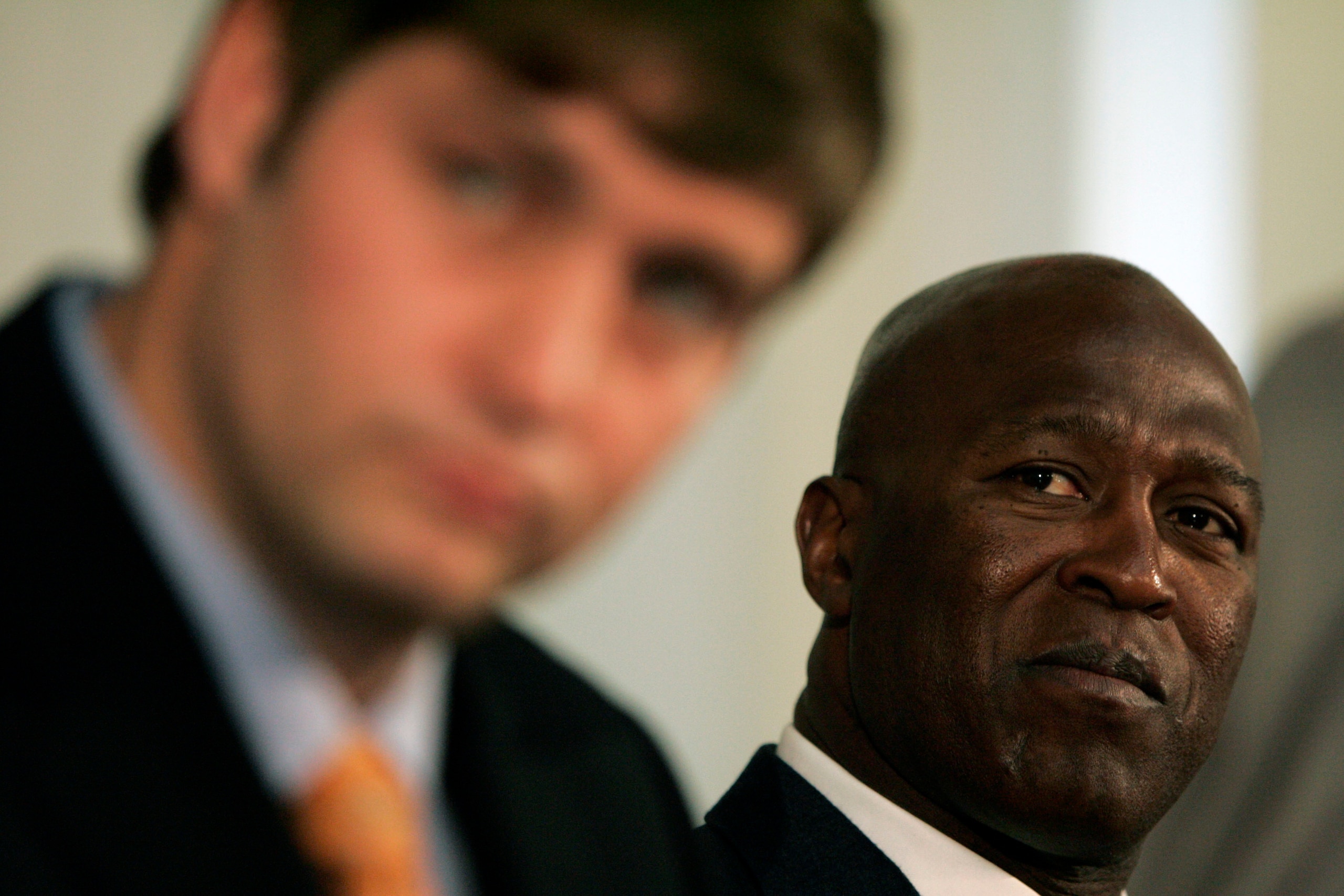 LAKE FOREST, IL - APRIL 3:  Chicago Bears head coach Lovie Smith looks on as new quarterback Jay Cutler talks to the media  during a press conference on April 3, 2009 at Halas Hall in Lake Forest, Illinois. (Photo by Jim Prisching/Getty Images)