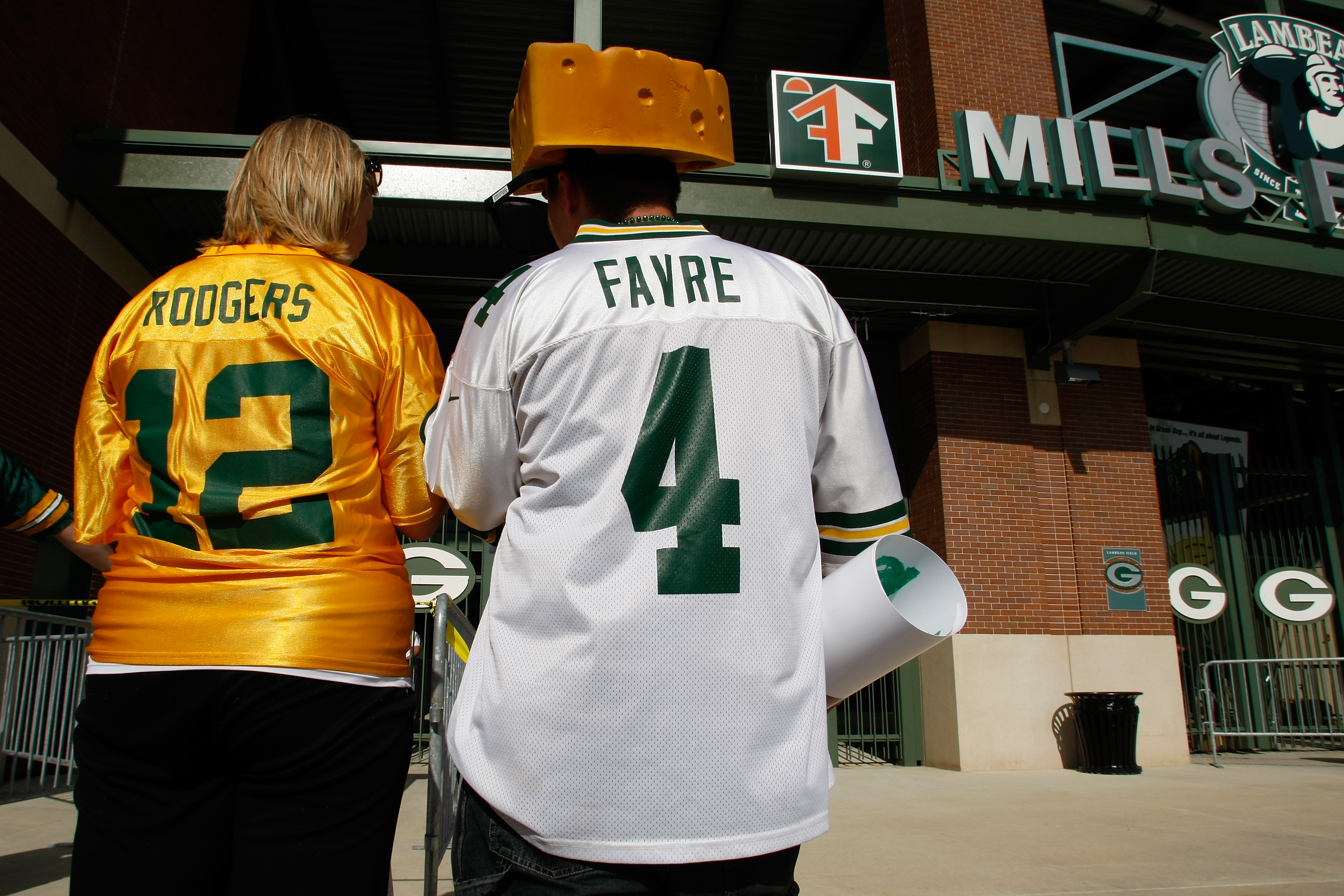 GREEN BAY, WI - AUGUST 11: Fans of Aaron Rogers along with a Brett Favre fan wear their respective jerseys as the enter  Lambeau Field prior to the game between the Green Bay Packers against the Cincinnati Bengals at the Lambeau Field on August 11, 2008 i