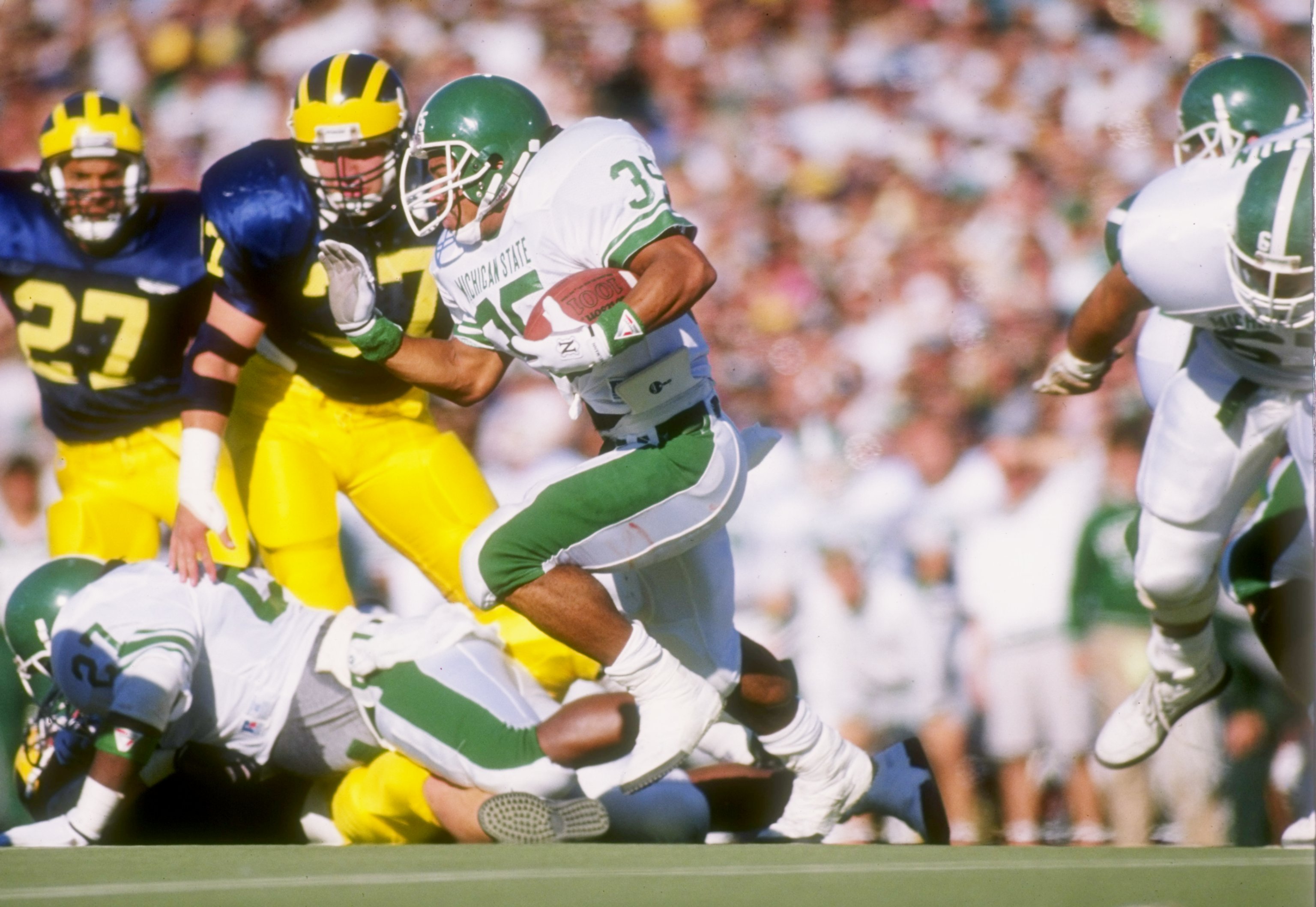 Running back Tico Duckett of the Michigan State Spartans runs down the field during a game.