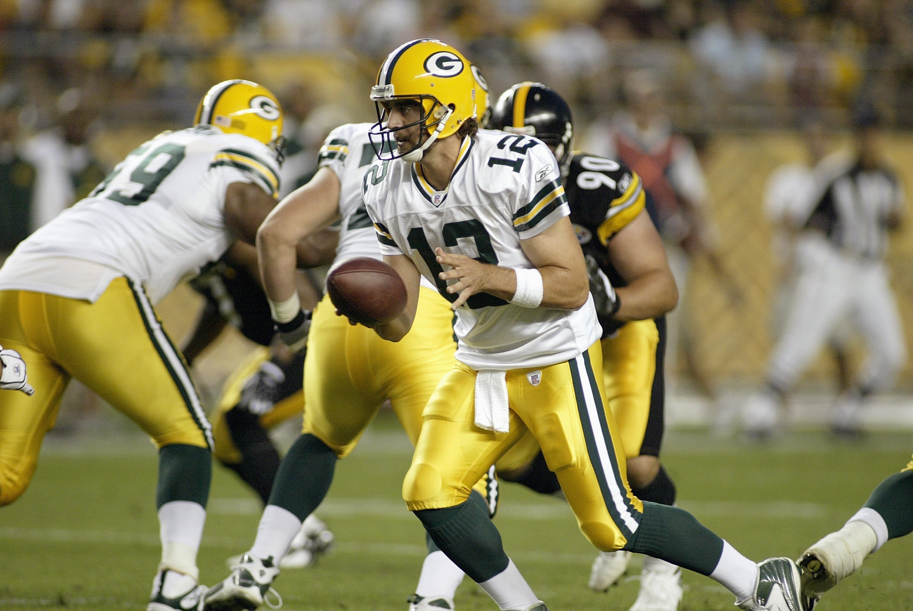 PITTSBURGH - AUGUST 11: Quarterback Aaron Rodgers #12 of the Green Bay Packers  moves to hand off the ball during the game against the Pittsburgh Steelers on August 11, 2007 at Heinz Field in Pittsburgh, Pennsylvania.  (Photo by Rick Stewart/Getty Images)