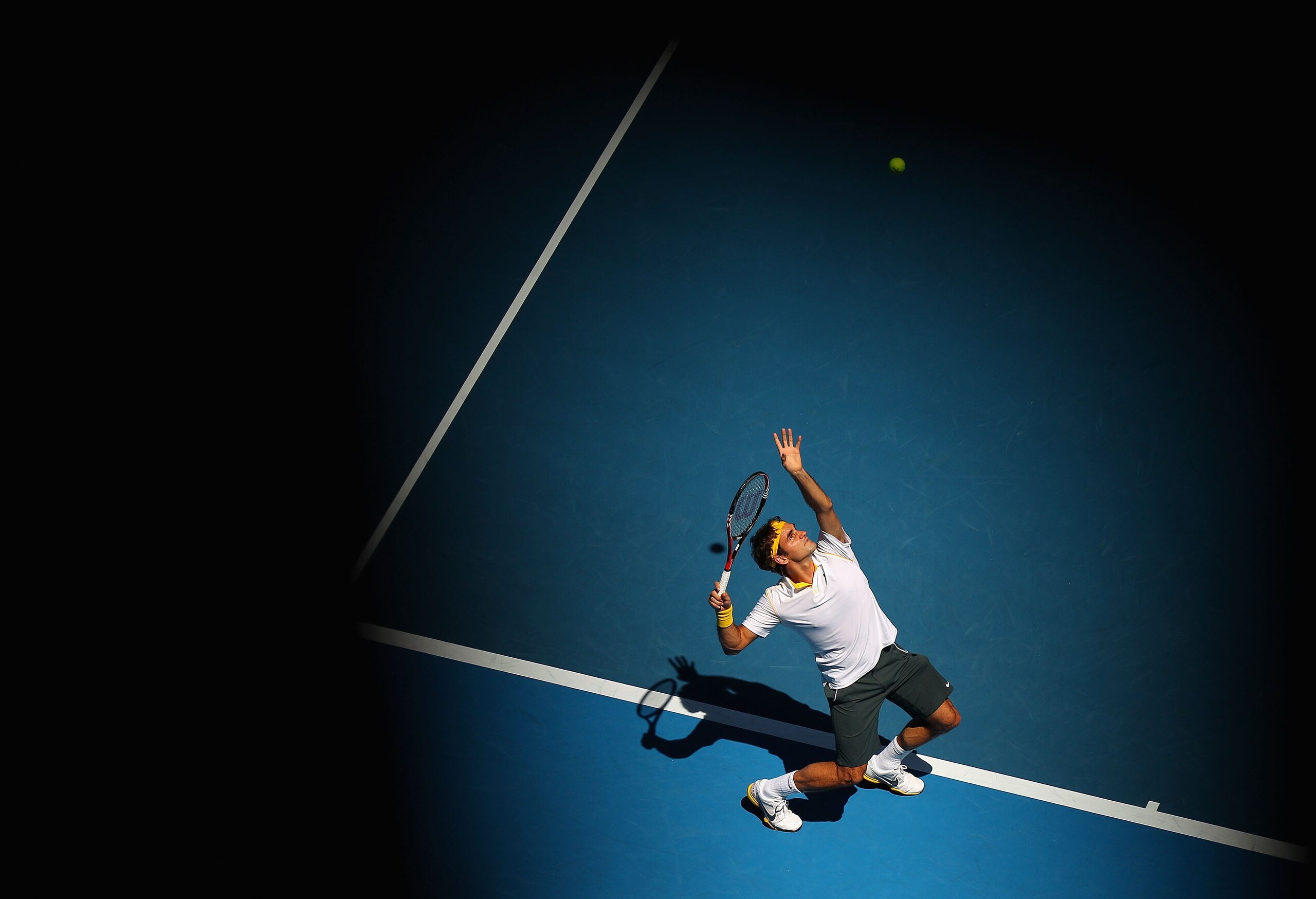 MELBOURNE, AUSTRALIA - JANUARY 23:  Roger Federer of Switzerland serves in his fourth round match against Tommy Robredo of Spain during day seven of the 2011 Australian Open at Melbourne Park on January 23, 2011 in Melbourne, Australia.  (Photo by Cameron