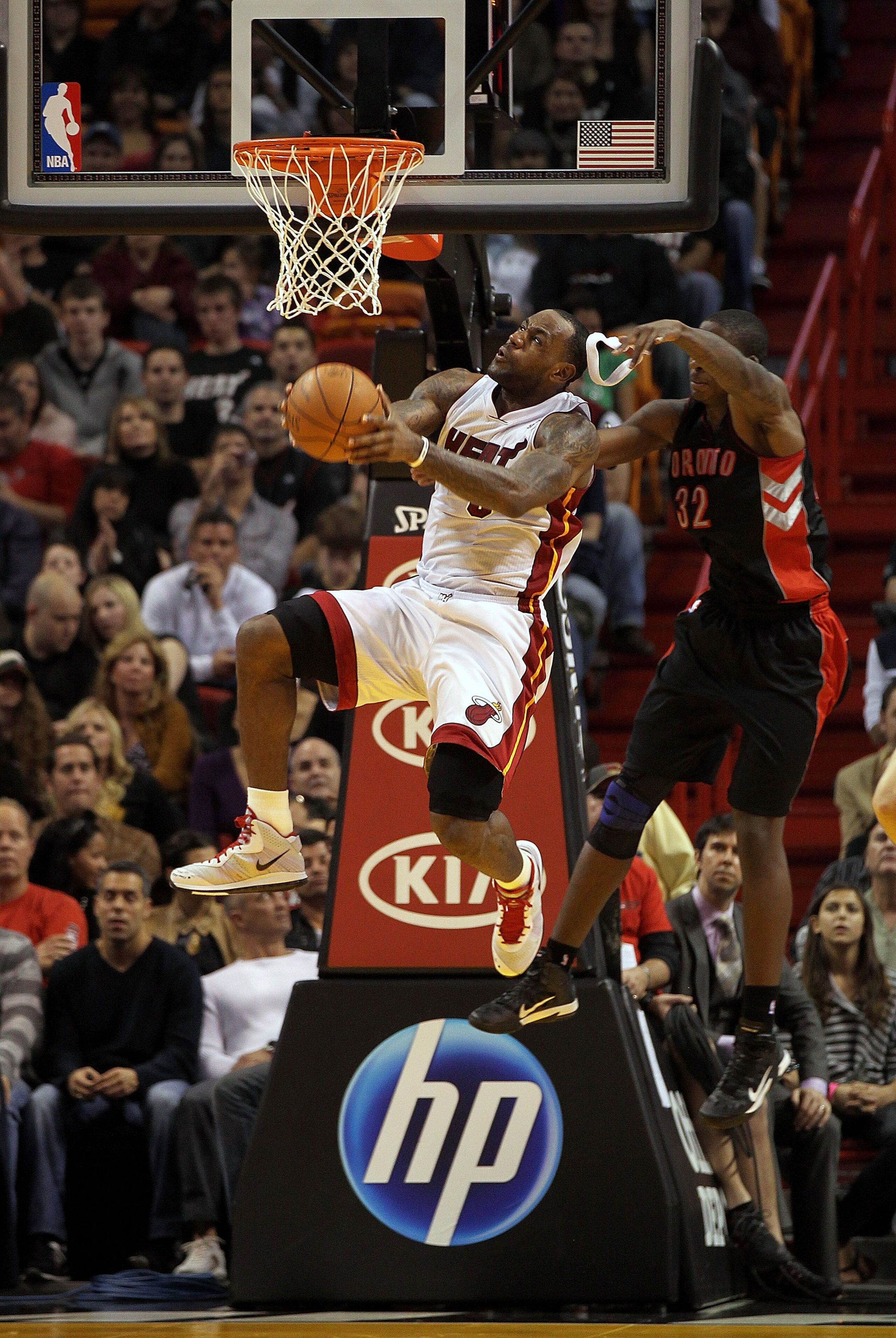 MIAMI, FL - JANUARY 22:  LeBron James #6 of the Miami Heat is fouled by Ed Davis #32 of the Toronto Raptors during a game  at American Airlines Arena on January 22, 2011 in Miami, Florida. NOTE TO USER: User expressly acknowledges and agrees that, by down