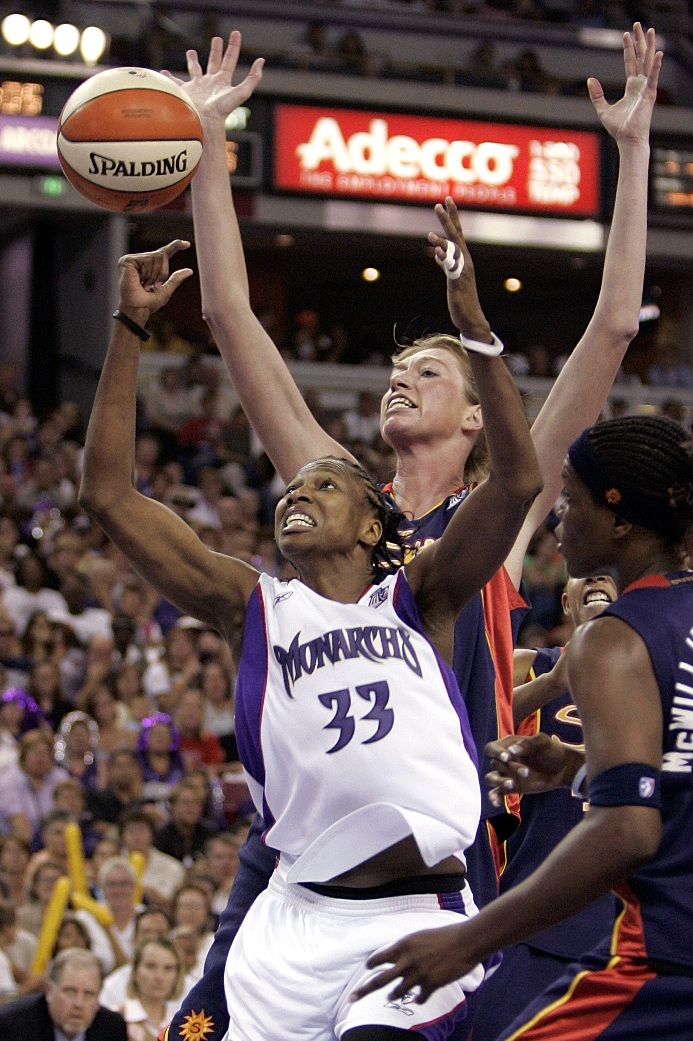 SACRAMENTO, CA - SEPTEMBER 18:   Yolanda Griffith #33 of the Sacramento Monarchs battles with Taj McWilliams-Fran #11 and Margo Dydek #12 of the Connecticut Sun during Game 3 of the WNBA finals on September 18, 2005 at the ARCO Arena in Sacramento, Califo