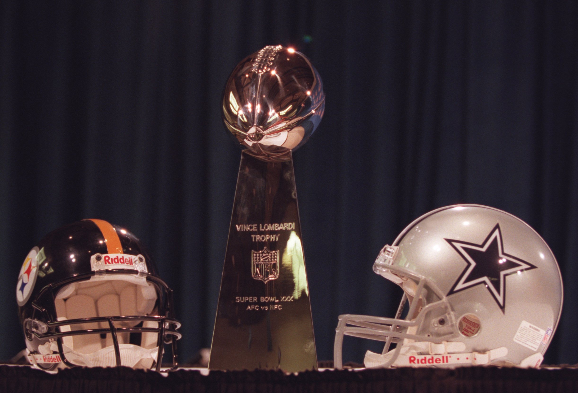 26 Jan 1996:  The Vince Lombardi Trophy (center) with helmets of the Dallas Cowboys (right) and Pittsburgh Steelers (left) during a news conference by commisioner Paul Tagliabue of the NFL for Super Bowl XXX in the Regency Ballroom at the Hyatt Regency Ho