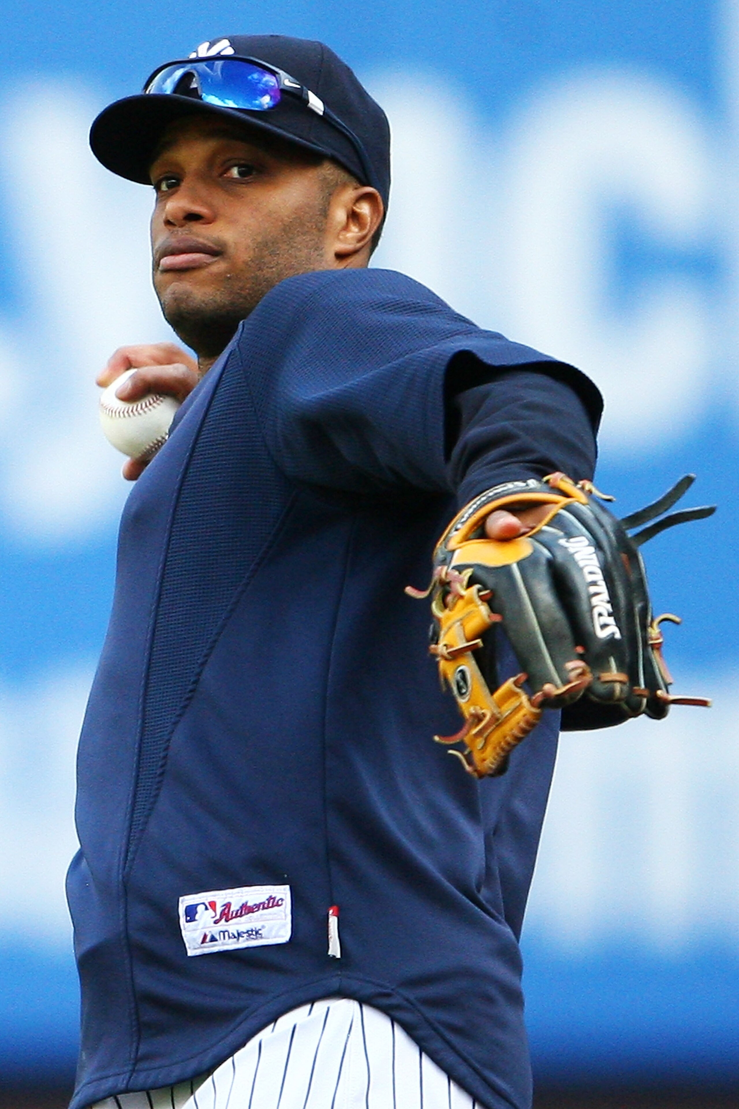 NEW YORK - OCTOBER 12: Robinson Cano #24 of the New York Yankees throws a ball during a workout session at Yankee Stadium on October 12, 2010 in the Bronx borough of New York City.  (Photo by Andrew Burton/Getty Images)