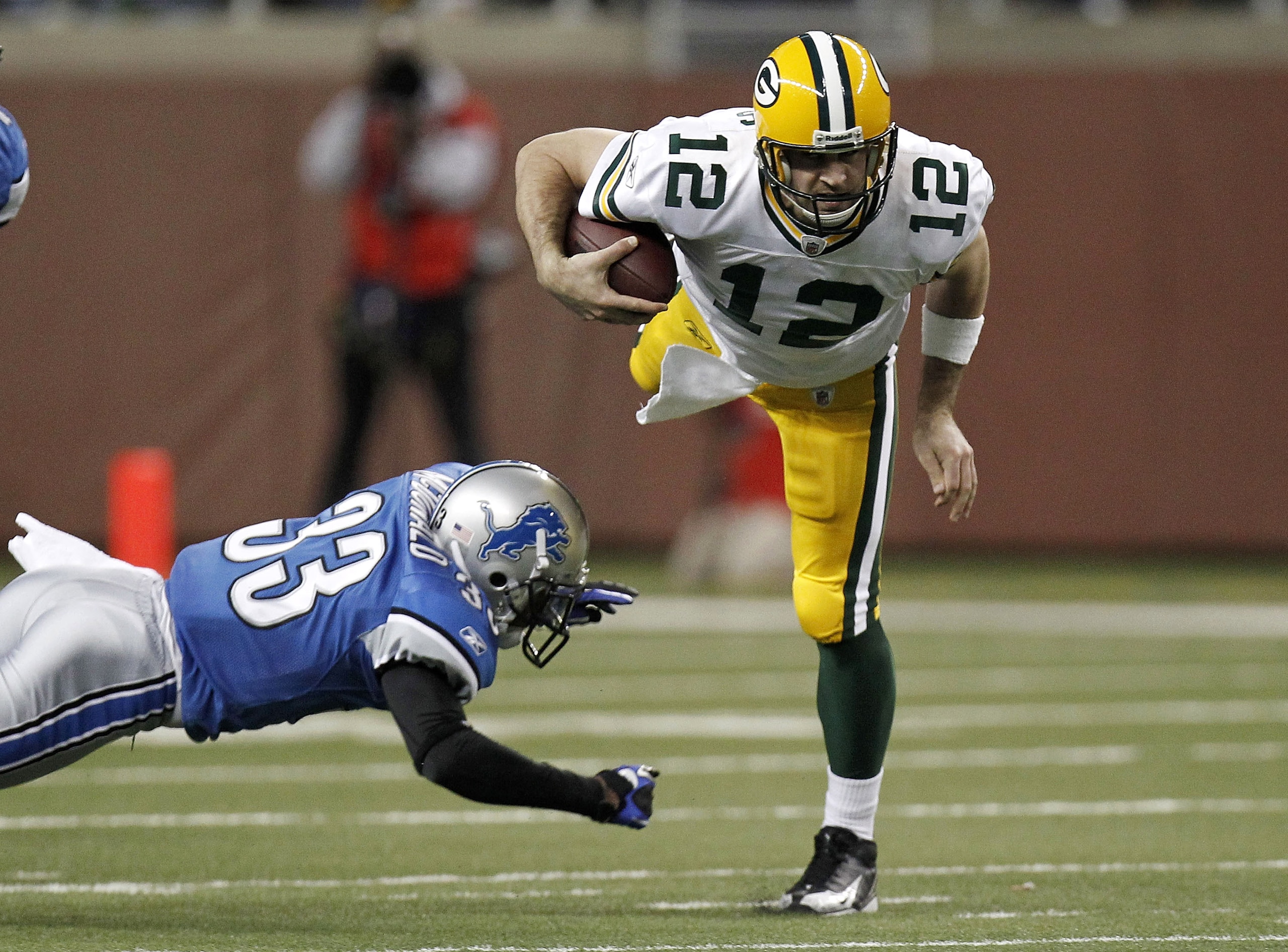DETROIT, MI - DECEMBER 12: Aaron Rodgers #12 of the Green Bay Packers is tackled during a second half run by Brandon McDonald #33 of the Detroit Lions on December 12, 2010 at Ford Field in Detroit, Michigan. (Photo by Gregory Shamus/Getty Images) DETROIT, MI - DECEMBER 12: Aaron Rodgers #12 of the Green Bay Packers is tackled during a second half run by Brandon McDonald #33 of the Detroit Lions on December 12, 2010 at Ford Field in Detroit, Michigan. (Photo by Gregory Shamus/Getty Images)