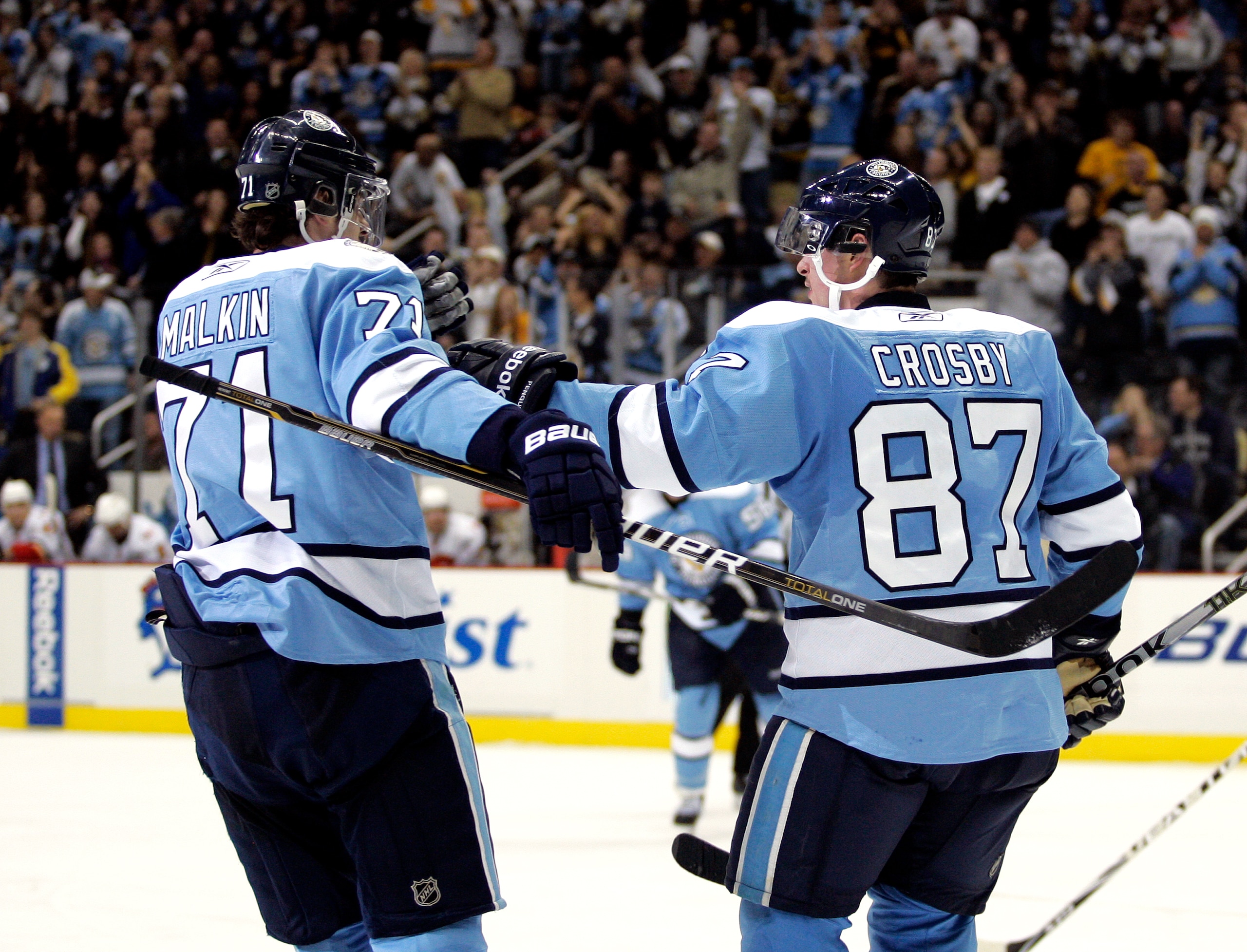PITTSBURGH - NOVEMBER 27:  Sidney Crosby #87 of the Pittsburgh Penguins celebrates his 200th career goal with Evgeni Malkin #71 against the Calgary Flames at Consol Energy Center on November 27, 2010 in Pittsburgh, Pennsylvania.  The Penguins defeated the