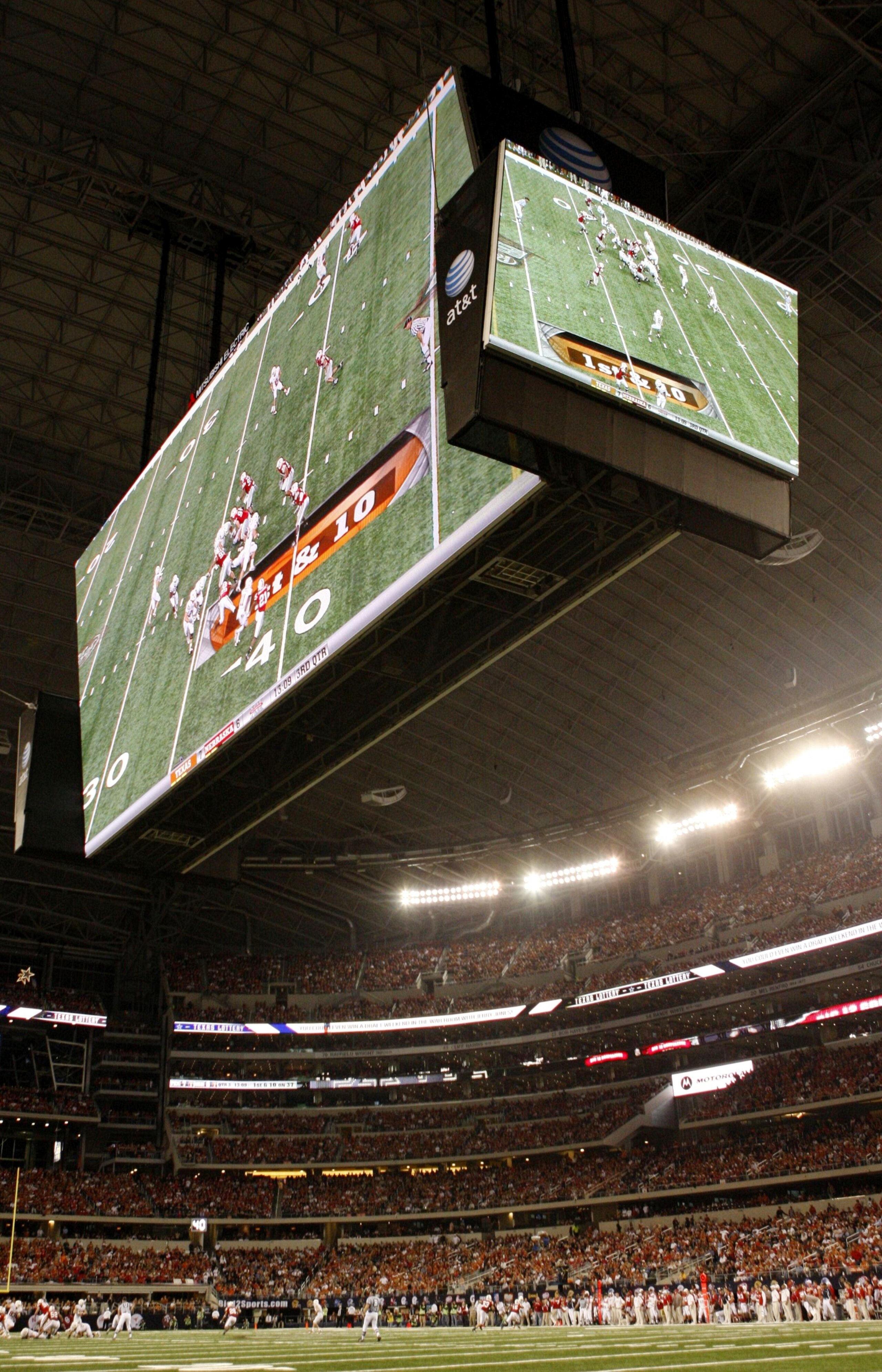 ARLINGTON, TX - DECEMBER 5:  The large television screens are seen over the field during the game between the Texas Longhorns and the Nebraska Cornhuskers at Cowboys Stadium on December 5, 2009 in Arlington, Texas.  (Photo by Ronald Martinez/Getty Images)
