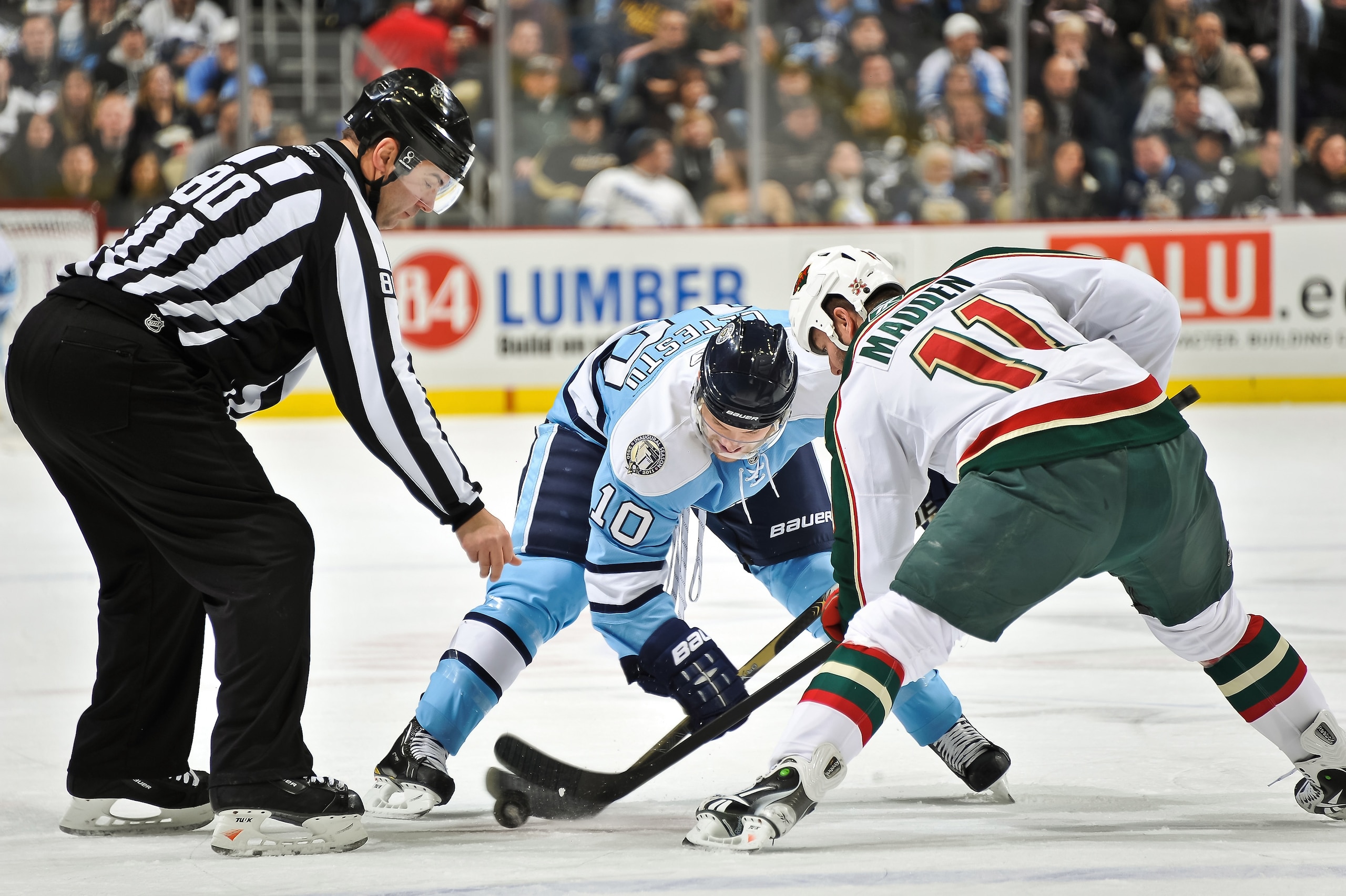 PITTSBURGH, PA - JANUARY 08:  Linesman Thor Nelson #80 of the NHL drops the puck on a faceoff between Mark Letestu #10 of the Pittsburgh Penguins and  John Madden #11 of the Minnesota Wild on January 8, 2011 at CONSOL Energy Center in Pittsburgh, Pennsylv