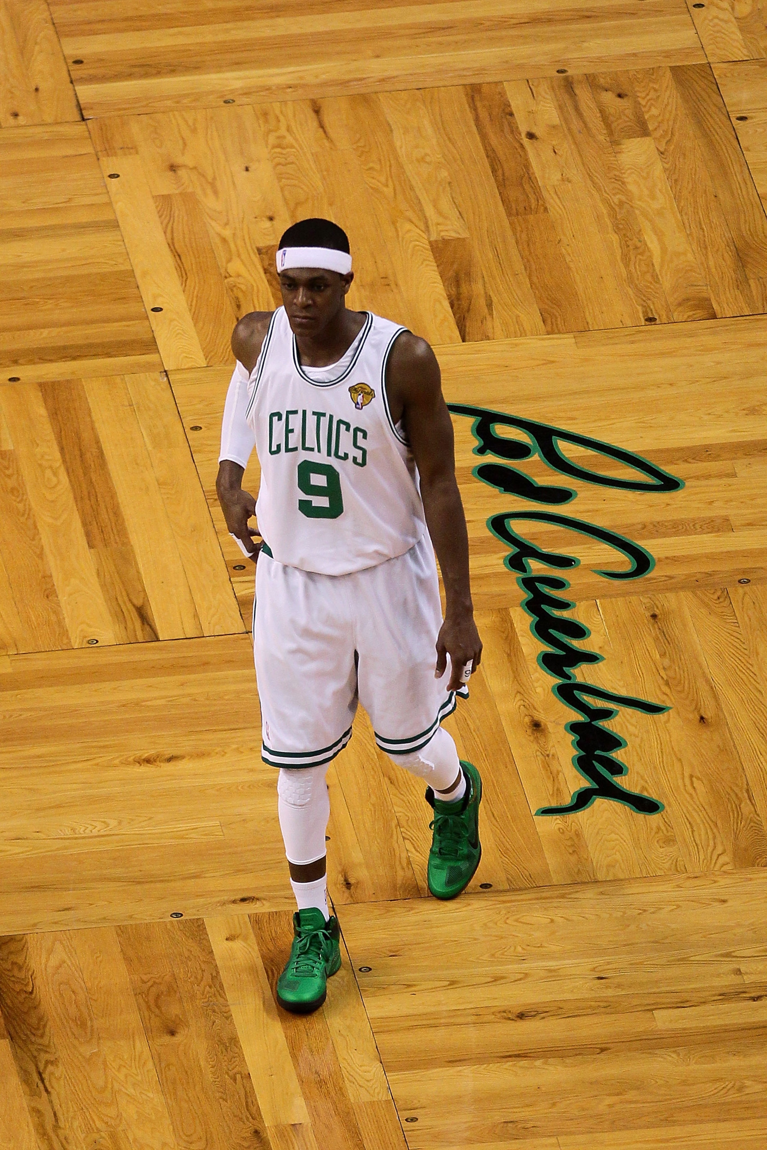 BOSTON - JUNE 08:  Rajon Rondo #9 of the Boston Celtics walks past a logo of Red Auerbach's signature in Game Three of the 2010 NBA Finals against the Los Angeles Lakers on June 8, 2010 at TD Garden in Boston, Massachusetts. NOTE TO USER: User expressly a